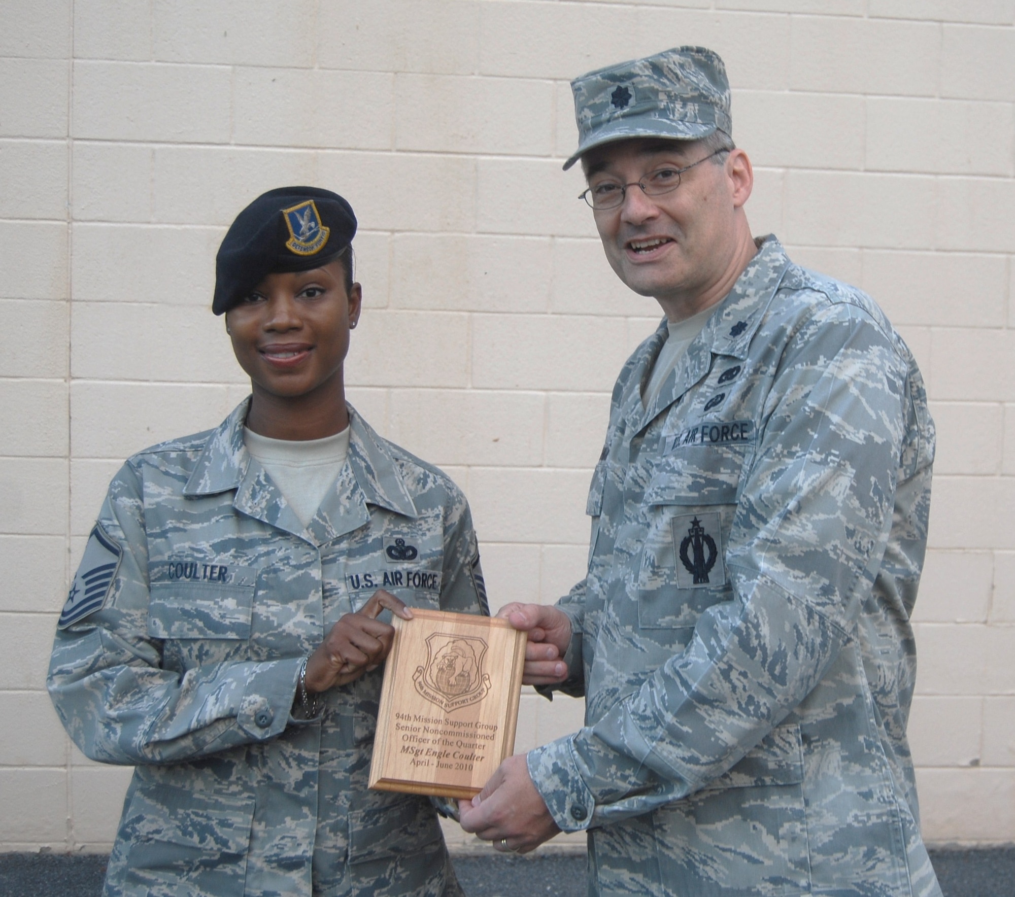 Lt. Col. Todd Laughman, 94 MSG/CC, presents a 2nd quarter winner's plaque to Master Sgt. Engle Coulter, 94 SFS, for the period covering April through June 2010.