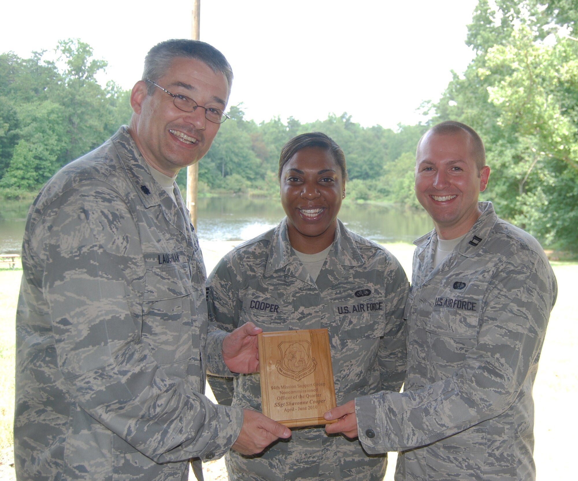 Lt. Col. Todd Laughman, 94 MSG/CC, and Capt. Nicholas Franz, 94 SVS/CC, present a 2nd quarter winner's plaque to Staff Sgt. Shavonne Cooper, 94 SVS, for the period covering April through June 2010.