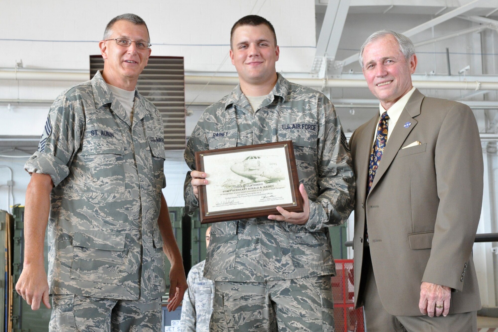 Staff Sgt. Ronald A Rainey, 917th Maintenance Squadron, munitions systems mechanic, poses for a photo with Chief Master Sgt. Keith St. Aubin, the 917th Wing command chief master sergeant, and Chief Master Sgt. (Ret) Jack Skaggs, after being inducted into the ranks of a United States Air Force Non-Commissioned Officer during the 917th Wing’s 2nd Annual NCO Induction Ceremony at the A-10 Hangar on Barksdale Air Force Base, La., Sept. 11, 2010. Chief Skaggs, who was the guest speaker at the event, is a former Command Chief Master Sergeant of the 917th Wing at Barksdale.  Approximately 25 Senior Airmen were promoted to the rank of staff sergeant during the ceremony. (U.S. Air Force photo by/Betty Stephens)
