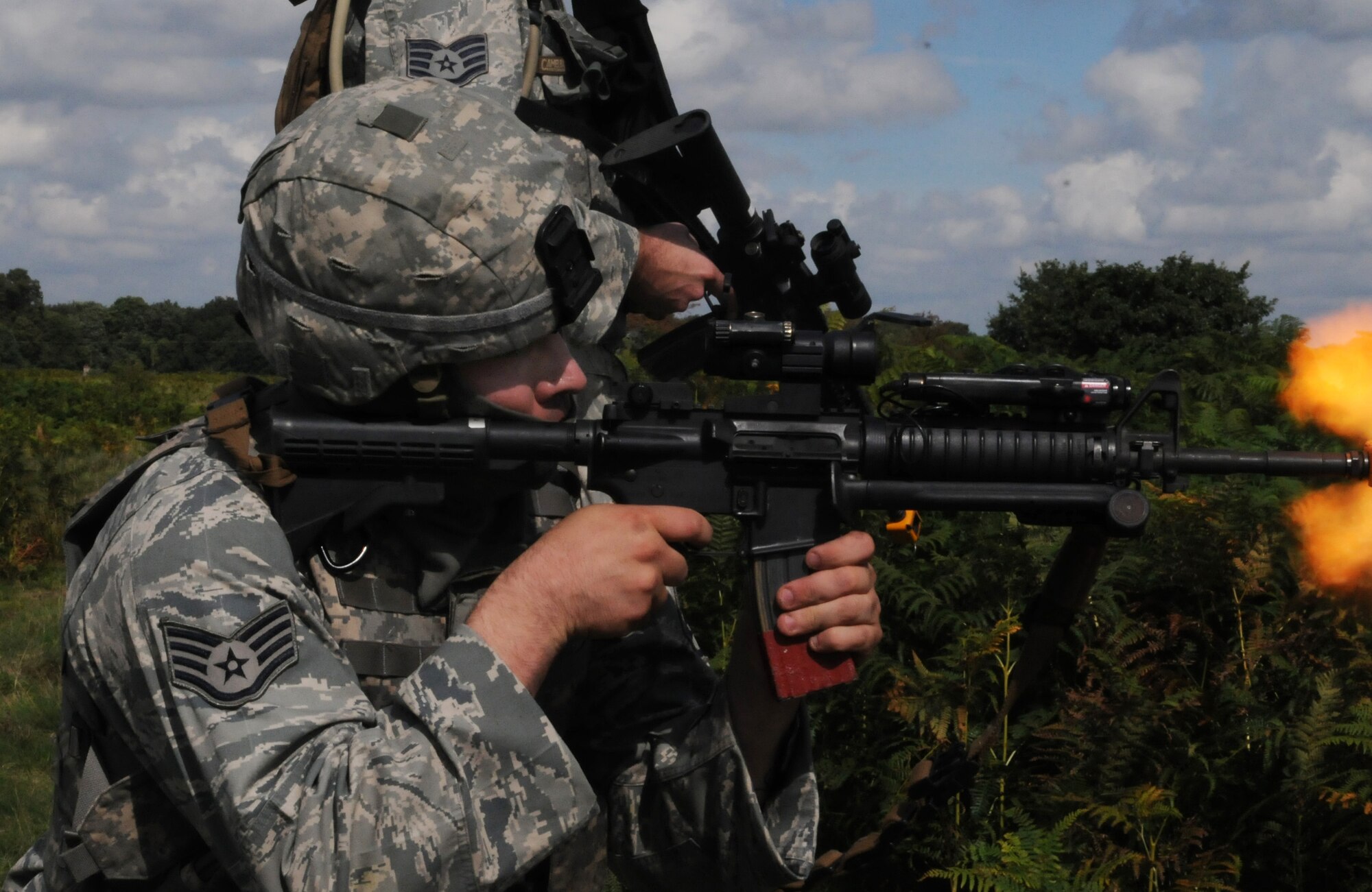 STANFORD TRAINING AREA, England -- Staff Sgt. Jon Anderson, 100th Security Forces Squadron, provides cover fire while conducting a danger crossing training scenario here Sept. 7. When not supporting the Royal Air Force Regiment in the field, more than 20 100th SFS Airmen held their own scenarios while they had access to the 30,000-acre training area. These Airmen were here to embed with British servicemembers who are about to deploy to Afghanistan to serve with U.S. Marines. This gave the regiment troops an idea of what it is like to work with United States forces. (U.S. Air Force photo/Staff Sgt. Thomas Trower) 