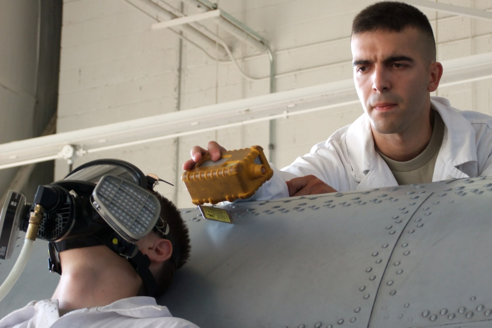Senior Airman Joaquin Martinez, 917th Maintenance Squadron, fuels systems
specialist, simulates taking a reading with an oxygen level meter during a
Confined Space Rescue Exercise conducted at the 917 Maintenance Squadron
fuels section hangar, Sept. 11, 2010. Fuels personnel from the 917th Wing
conducted the training for 917 WG and 2nd Bomb Wing personnel who work
together under the Total Force Integration program at Barksdale AFB.
Qualified confined space personnel assigned to the 917 MXS Fuels Section and
authorized fire department personnel are required to have hands-on practice
in removing simulated victims (such as dummies, mannequins, or actual
persons) from actual or representative confined spaces having openings and
portals like the types from which rescue is to be performed. The training,
which is required Air Force wide, is work center specific where hazardous
environments exist. Practice for each team member is conducted initially,
and then required at least once every 12 months thereafter. Rescue personnel
are trained on rescue duties and responsibilities, use of retrieval and
rescue equipment, proper wear and use of personal protection equipment, CPR
and basic first-aid. (U.S. Air Force photo/Master Sgt. John Reser) 
