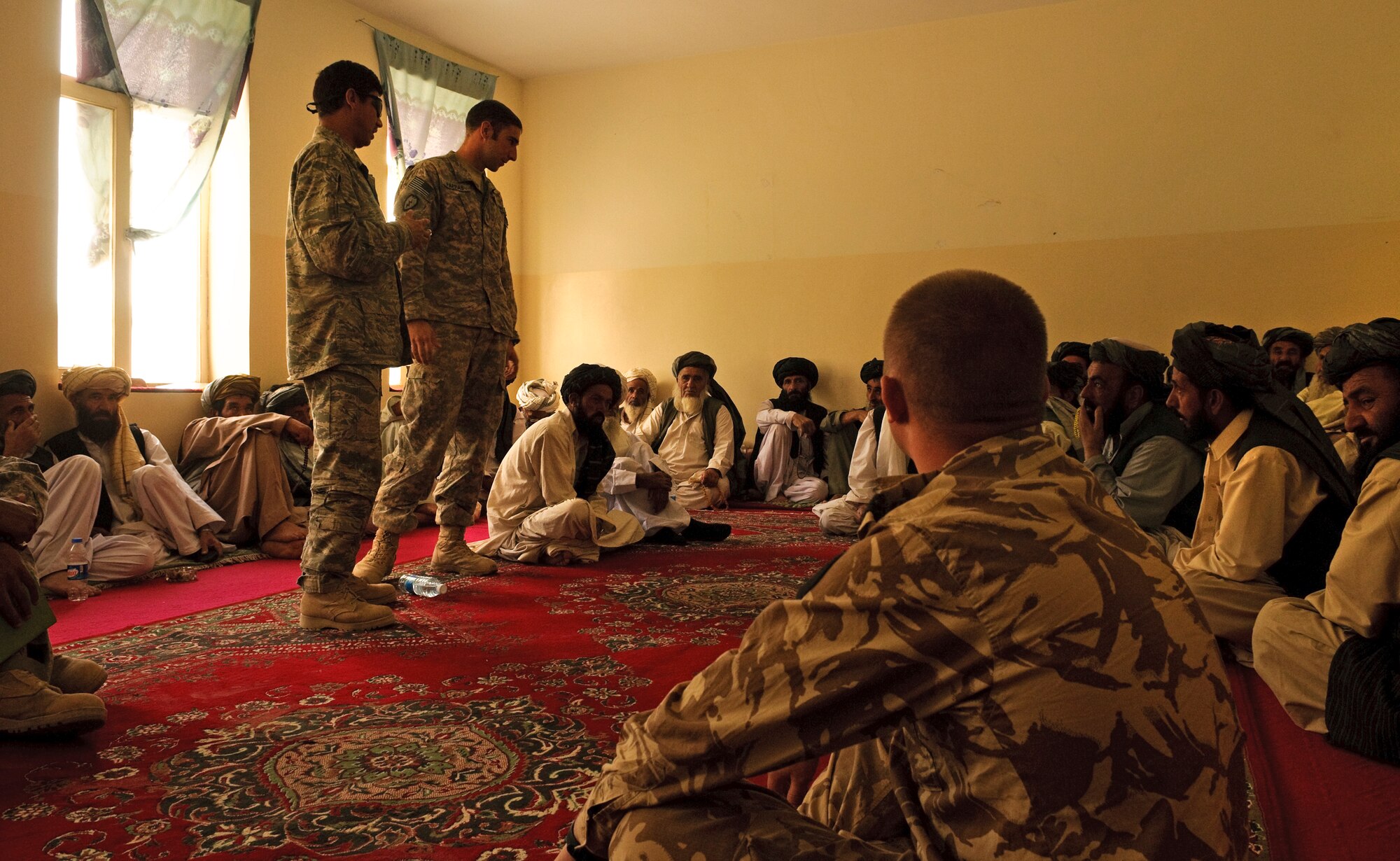 FORWARD OPERATING BASE BULLARD, Afghanistan - U.S. Army Capt. Maxwell Pappas, Provincial Reconstruction Team Zabul district support unit leader, speaks to local Afghan elders during an election shura at the Shah Joy District Center, Shah Joy District, Zabul province, Sept. 13. Local elders attended the shura to discuss the upcoming provincial parliamentary elections and to celebrate the end of Ramadan with Shah Joy District Chief Abdul Qayum.  (U.S. Air Force Photo/Senior Airman Nathanael Callon/Released)
