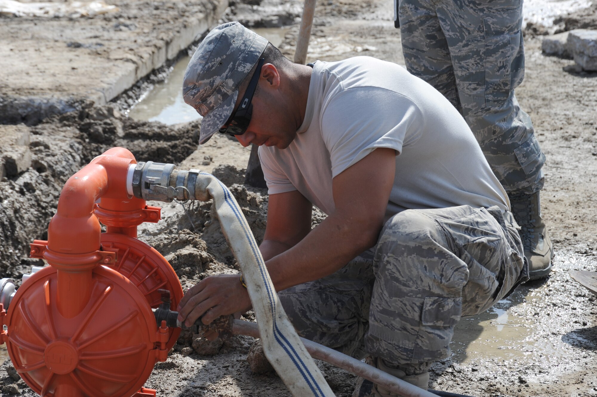Tech. Sgt. Anthony Macias, , 380th Civil Engineer Squadron NCO in charge water fuels system maintenance, operates a water pump in order to pump water away from a broken water main Sept. 14, 2010, at an undisclosed location in Southwest Asia. (U.S. Air Force photo/Tech. Sgt. April Wickes) 