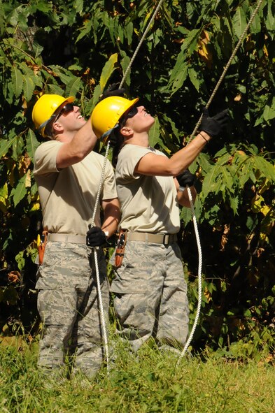 Staff Sgt. Alf Alexis and Airman 1st Class Christian Dolbin, both cable and antenna installers for the 211th Engineering Installation Squadron carefully guide the new VHF antenna as a motorized pulley system transports it up the tower where four Airmen wait to attach it to the mast they installed. The installation of this antenna allowed the Airmen of the 211th to get valuable on the job training while also being able to provide for the local community at the same time.