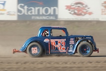 MANDAN, N.D. -- Tech. Sgt. Cameron D. Sogge, 5th Maintenance Group Weapons Standardization Team squadron lead load crew chief at Minot Air Force Base, races to the front during a heat race at the Dacotah Speedway here during the summer of 2010. Sergeant Sogge is not only a load crew chief, but is a member of the NODAK Race Club and a circle track dirt racing enthusiast, racing anywhere from 15 to 25 races a year. (Courtesy photo) 