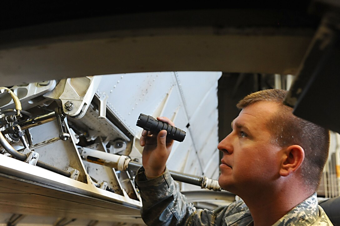 ELLSWORTH AFB, S.D. - Staff Sgt. Daniel Rice, 28th Maintenance Group quality assurance inspector, inspects a B-1B Lancer’s wing flap actuator and hydraulic lines for any damage, Sept. 9. Sergeant Rice conducts the check as part of the 150-days home station follow-up inspection. (U.S. Air Force photo/Senior Kasey Close)