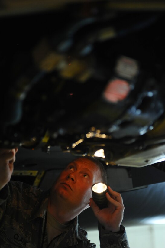 ELLSWORTH AFB, S.D. - Tech. Sgt. Barry Clark, 28th Maintenance Group quality assurance inspector, examines an accessory drive gearbox on a B-1B Lancer, Sept. 9. Sergeant Clark looks for any chaffing of electrical harnesses or hydraulic lines, security of duct clamps and oil fittings and fluid leaks as part of the 150-days home station follow-up inspection. (U.S. Air Force photo/Senior Kasey Close)