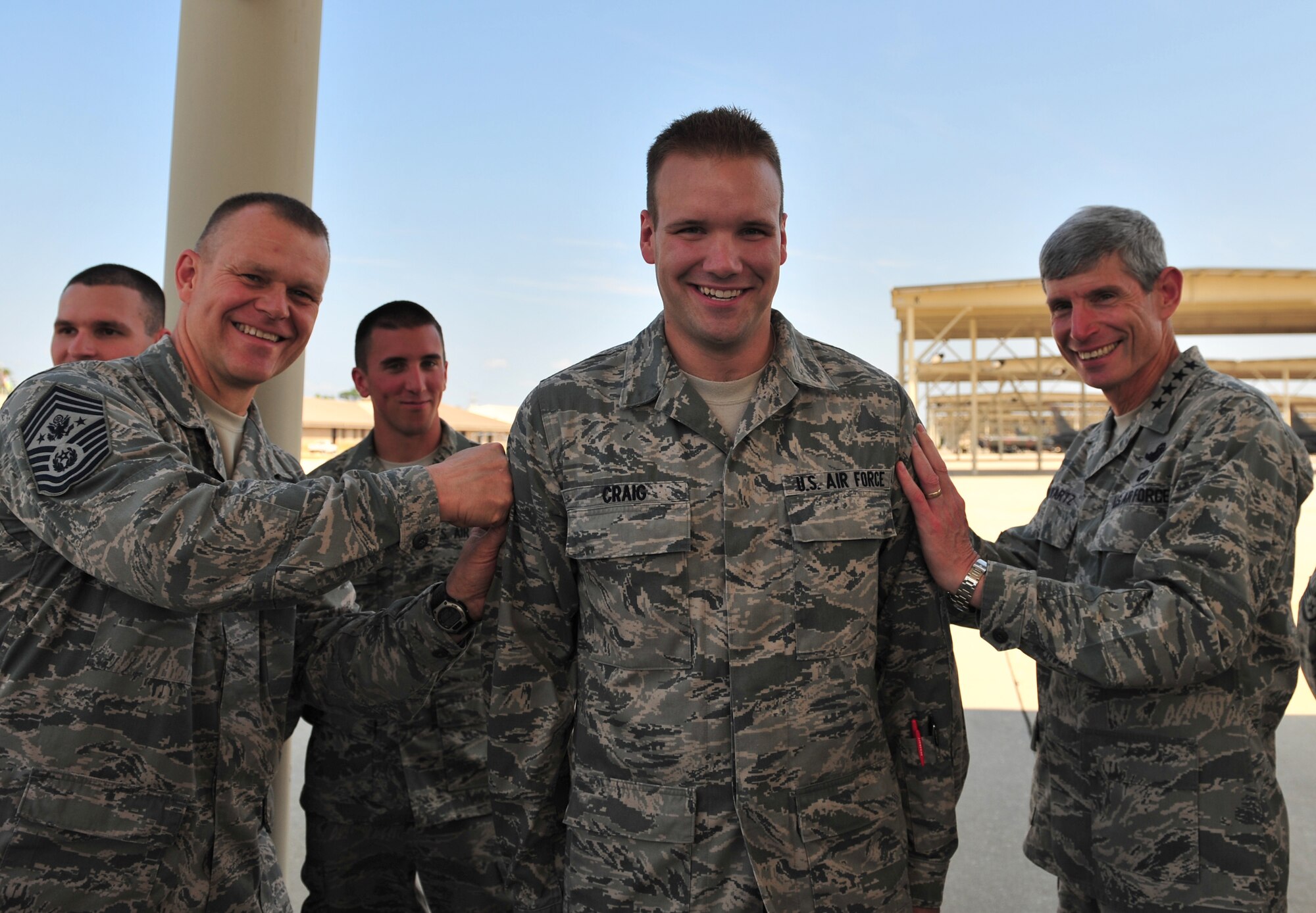 100908-F-8430J-236
SHAW AIR FORCE BASE, S.C. - Airman 1st Class Joshua Craig, 20th Maintenance Group, gets a new stripe
symbolically tacked on by Air Force Chief of Staff Gen. Norton Schwartz
(right) and Chief Master Sgt. of the Air Force James Roy (left) at Shaw Air
Force Base, S.C., on Sept. 8, 2010. General Schwartz and Chief Roy surprised
Airman Craig with the news that that he was a below-the-zone select to
senior airman during their visit to Shaw AFB. (U.S. Air Force photo/Airman
1st Class Amber E. N. Jacobs (Released)
