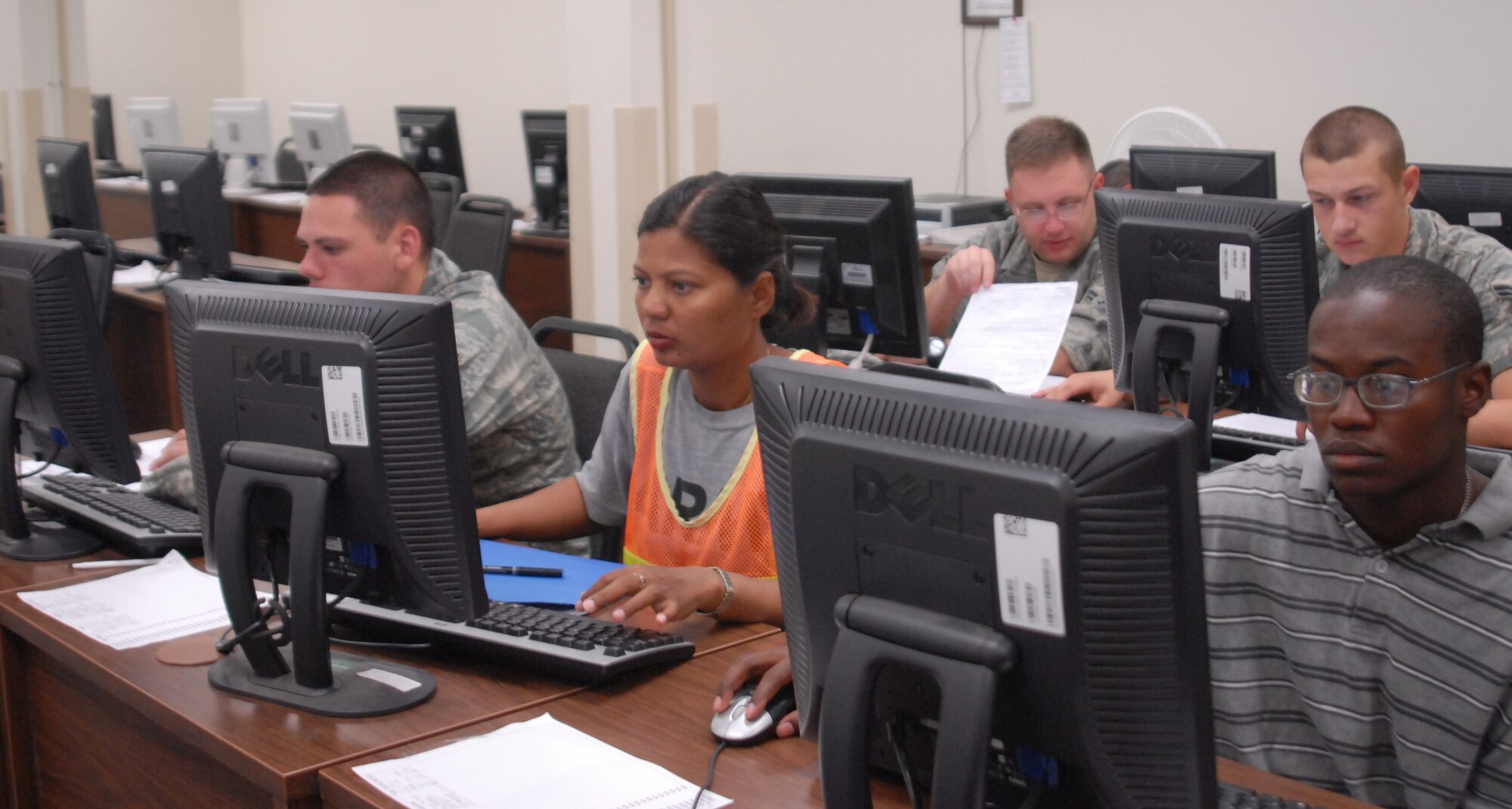 Servicemembers moving to a new duty location complete their moving forms at the Traffic Management Office's new Internet room during a Personal Baggage briefing Sept. 6. The Internet room also offers servicemembers an opportunity to receive hands-on assistance while manuevering through the Defense Personal Property System program. (U.S. Air Force photo/Connie Hempel)