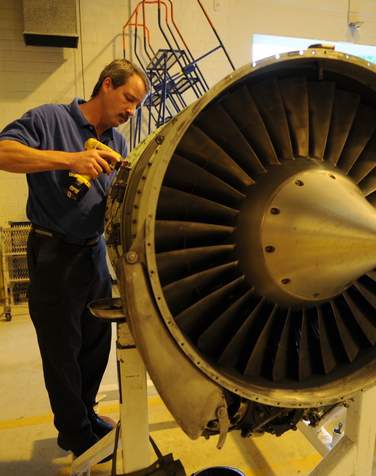 Perry Palhamus, DynCorp International C-21A aircraft mechanic, dismantles a turbine engine shroud during an engine swap, Ramstein Air Base, Germany, Sept. 13, 2010. DynCorp International helps play a major role in the success of the Ramstein mission by providing maintenance-essential functions of their C-21 for continued distinguished visitor support, aeromedical evacuation missions and U.S. African Command missions 24 hours a day, year round at six worldwide main operating bases and one overseas-extended deployment base. (U.S. Air Force photo by Senior Airman Caleb Pierce)