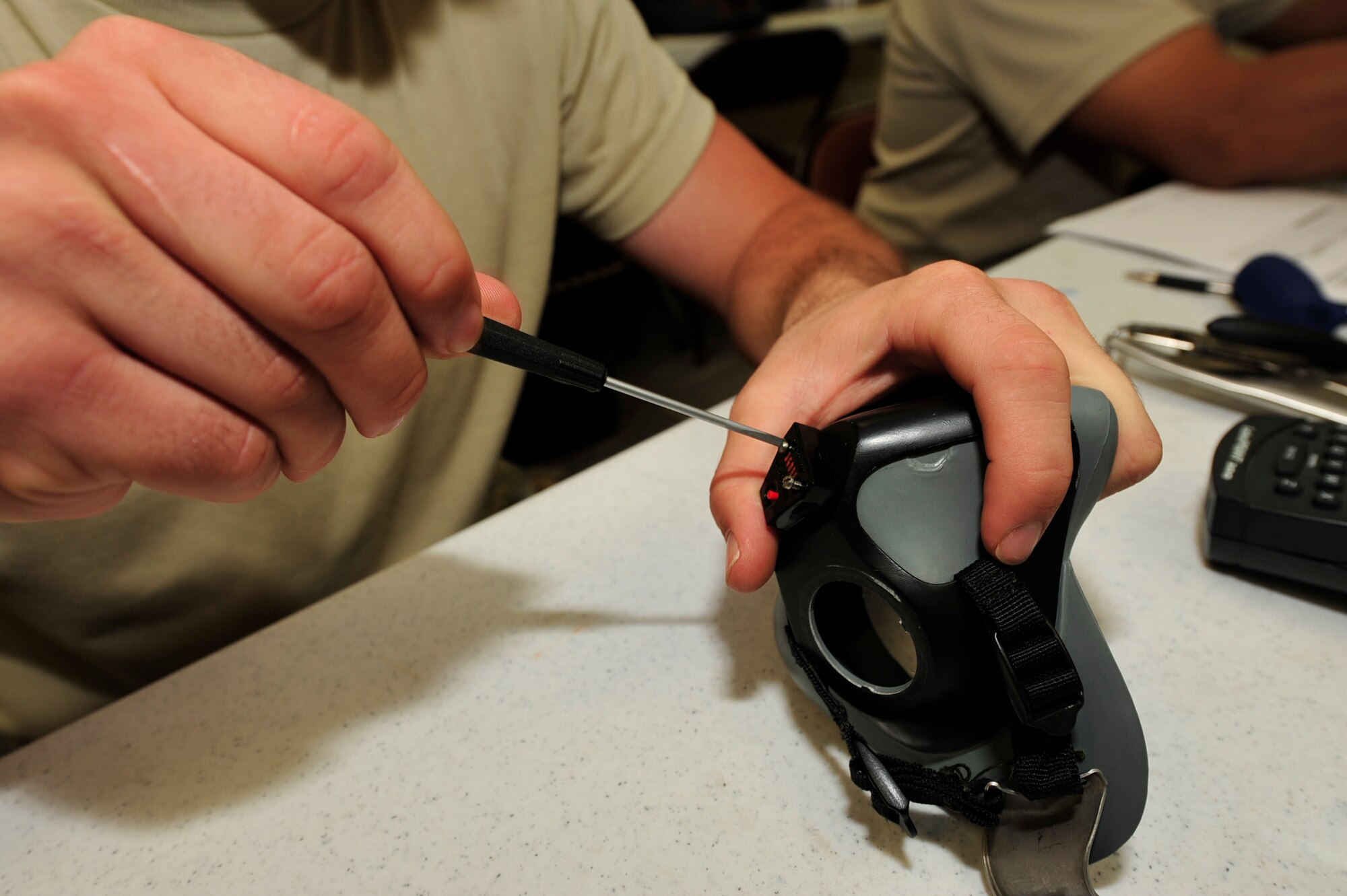 Airman 1st Class Thomas Adams, 44th Fighter Squadron, disassembles and re-assembles a flight helmet during the Valiant Shield exercise at Andersen Air Base, Guam, September 14, 2010. Valiant Shield is a joint service exercise that focuses on training and interoperability while responding to a range of mission scenarios.  (U.S. Air Force Photo/Staff Sgt. Lakisha A. Croley)