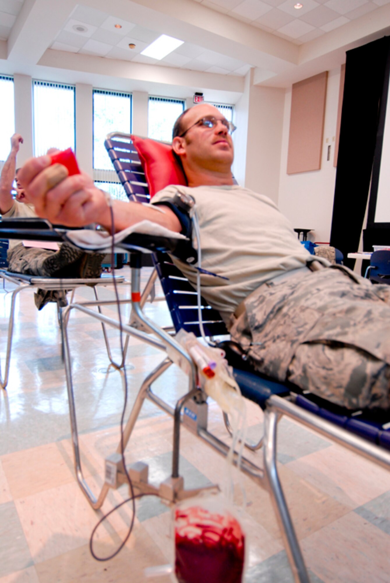 Technical Sgt. James Gerschutz, 180th Fighter Wing, donates blood at a Red Cross blood drive hosted at the 180th Fighter Wing, September 8. The 180th FW has been hosting blood drives for unit members since 2004. Throughout that time, 180th members have donated 438 units of blood. (U.S. Air Force Photo by Master Sgt. Beth Holliker/Released).