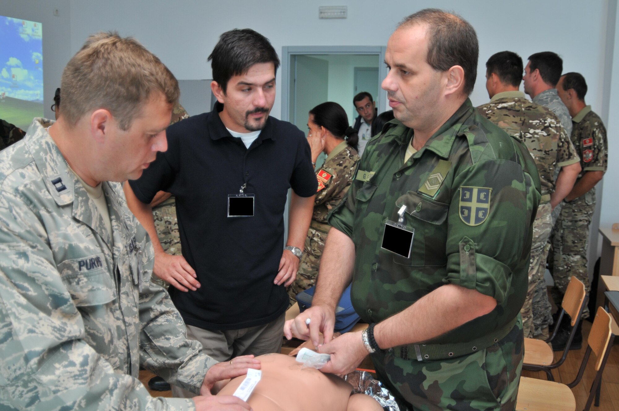 (left to right) U.S. Air Force Capt. Charles Purvis, a critical care nurse from the 48th Medical Operations Squadron at RAF Lakenheath England; Marko Saric, a physician’s assistant from Bosnia and Herzegovina, and Warrant Officer Goran Gavrilovic of the Serbian Army, discuss treatment for a collapsed lung during a class at MEDCEUR10 Sept. 14 at Danilovgrad Army Base, Montenegro. MEDCEUR10 is a medical training exercise including servicemembers from 10 nations. For more information, go to www.usafe.af.mil/medceur.asp and www.odbrana.gov.me. (U.S. Air Force photo/Senior Airman David Dobrydney)