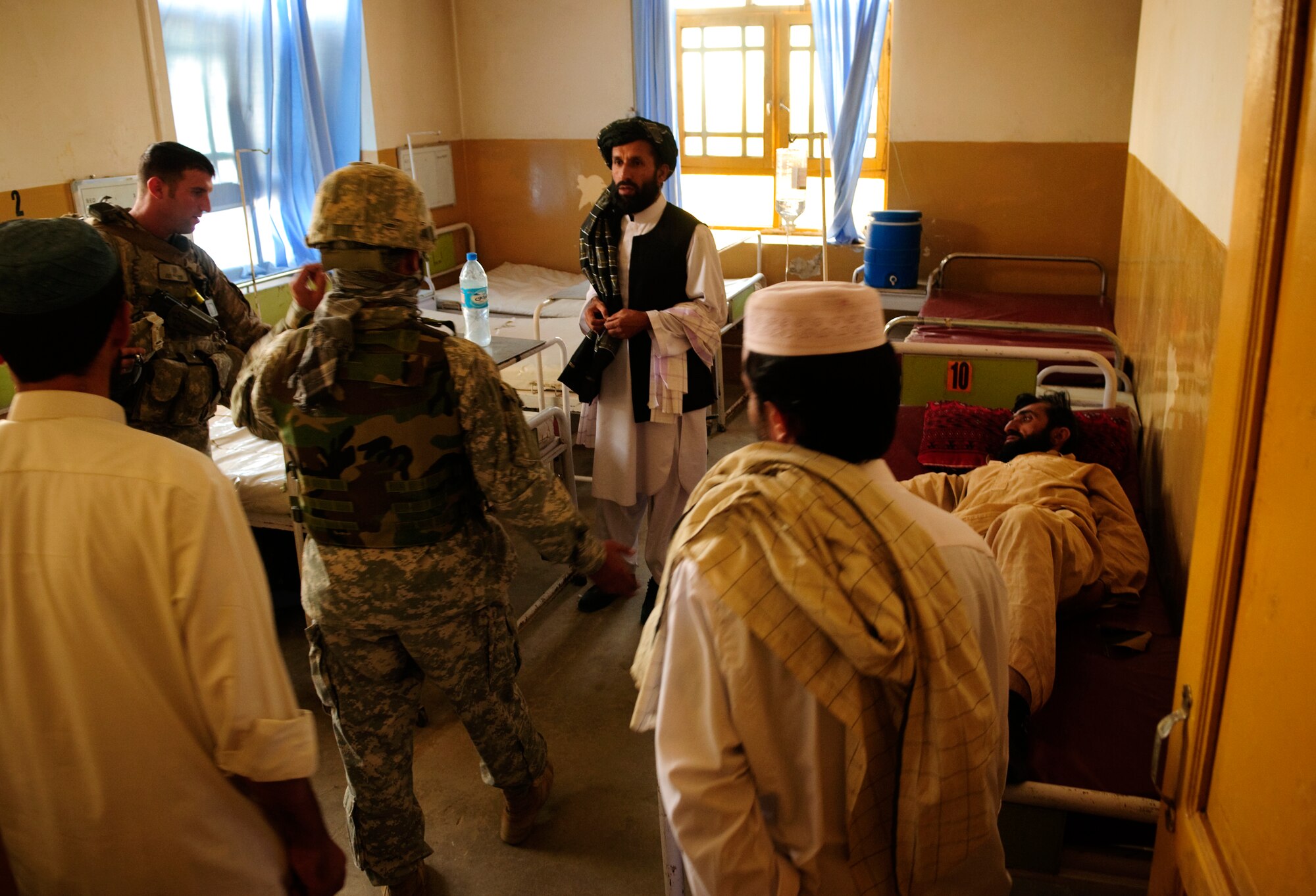 FORWARD OPERATING BASE BULLARD, Afghanistan - U.S. Air Force Staff Sgt. Jack Williams, left, a medic assigned to Provincial Reconstruction Team Zabul, uses an interpreter to communicate with medical workers during an inspection at Shah Joy District Hospital, Shah Joy District, Zabul province, Sept. 11, 2010. The PRT inspected the hospital to assess the repair needed for an upcoming renovation. (U.S. Air Force Photo/Senior Airman Nathanael Callon/Released)