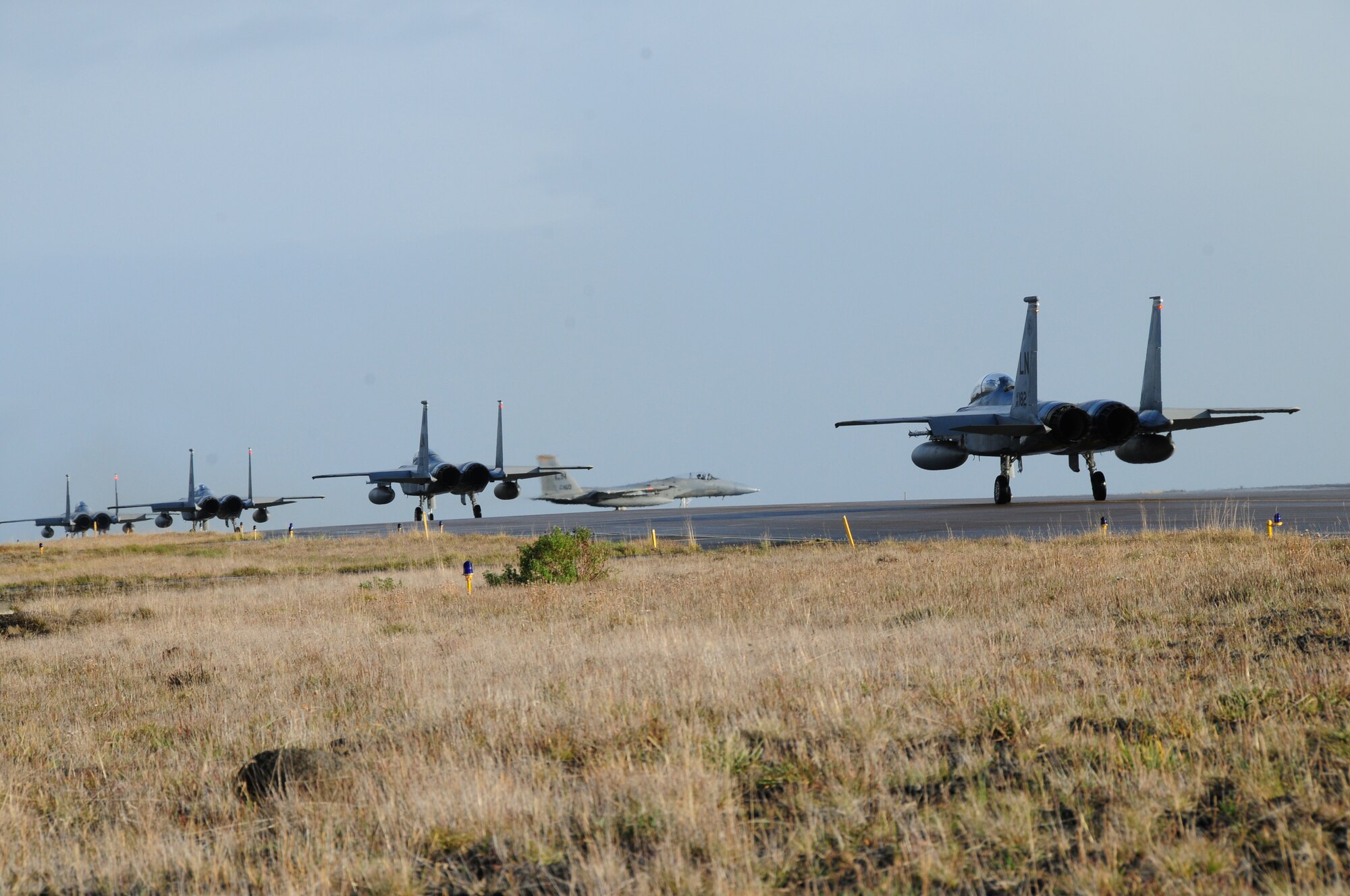 KEFLAVIK, Iceland - Three F-15C and one F-15D aircrafts wait on the taxiway as one F-15C prepares to take off Sept. 13, 2010. The F-15D is a two-seat variant of the F-15C. The 493rd Expeditionary Fighter Squadron, deployed from RAF Lakenheath, England, has been maintaining the NATO air policing mission here since September 6, 2010.   (U.S. Air Force photo/Senior Airman Stephen Linch)