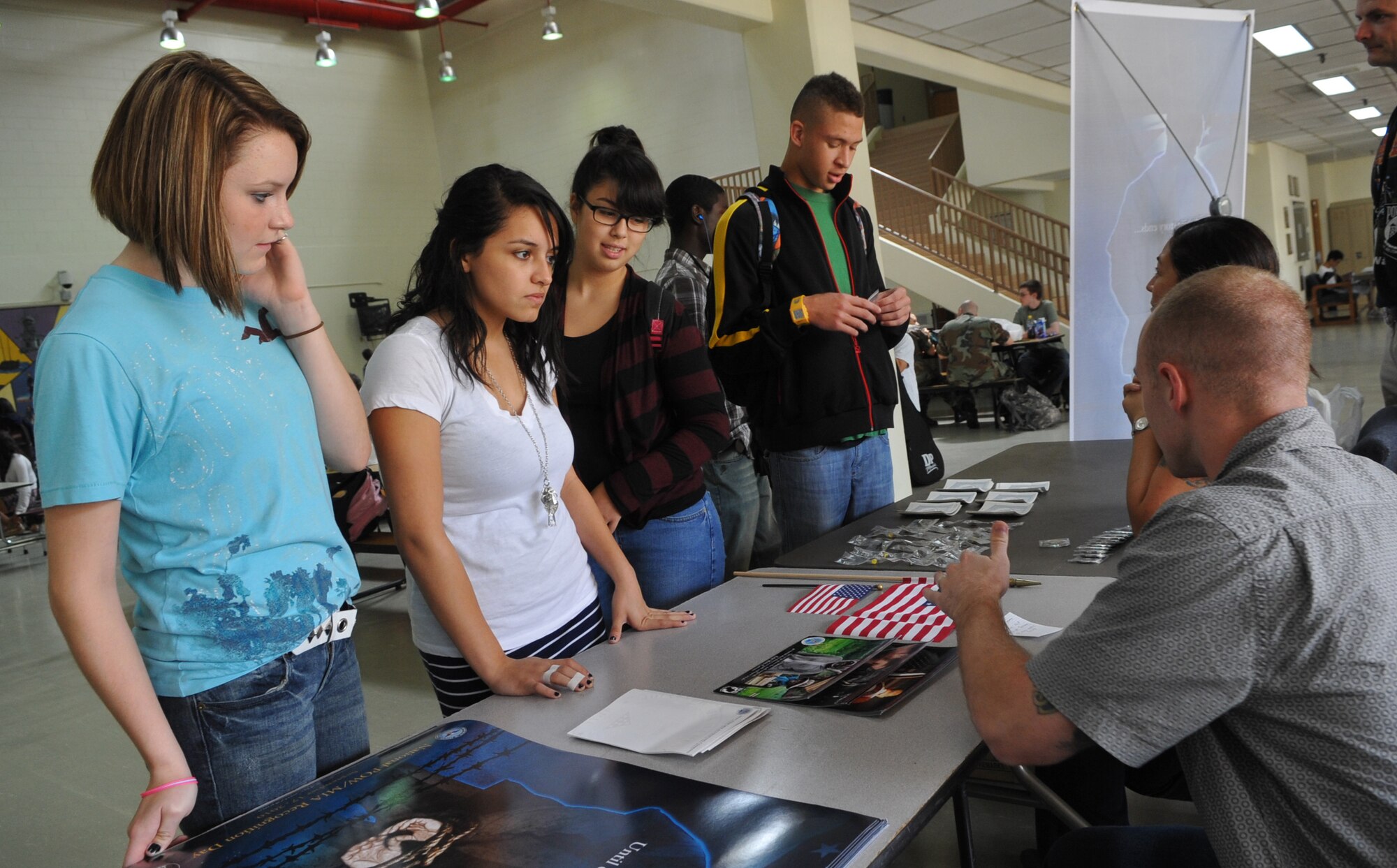 Osan American High School Students gather around a POW/MIA information table at Osan Air Base, Republic of Korea, Sept. 14. The base will honor the National POW/MIA Day the entire week of Sept. 13-17. National POW/MIA Recognition Day is annually observed in the United States on the third Friday of September. (U.S. Air
Force photo/Senior Airman Evelyn Chavez)