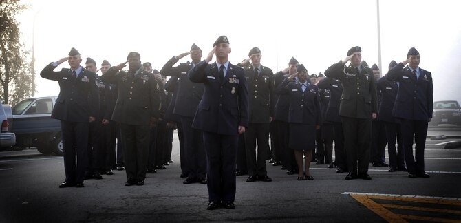 Airmen and Soldiers salute during a reveille ceremony Sept. 13, 2010 at Osan Air Base, Republic of Korea, the first of several events this week leading up to National POW/MIA Day. Osan will honor the POW/MIA Day the entire week of Sept. 13-17. National POW/MIA Recognition Day is annually observed in the United States on the third Friday of September. (U.S. Air Force photo illustration/Senior Airman Evelyn Chavez) 