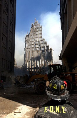 New York, N.Y. (Sept. 13, 2001) -- A New York City fire fighter looks up at what remains of the World Trade Center after its collapse during the Sept. 11 terrorist attack. U.S. Navy Photo by Photographer's Mate 2nd Class Jim Watson. (RELEASED)