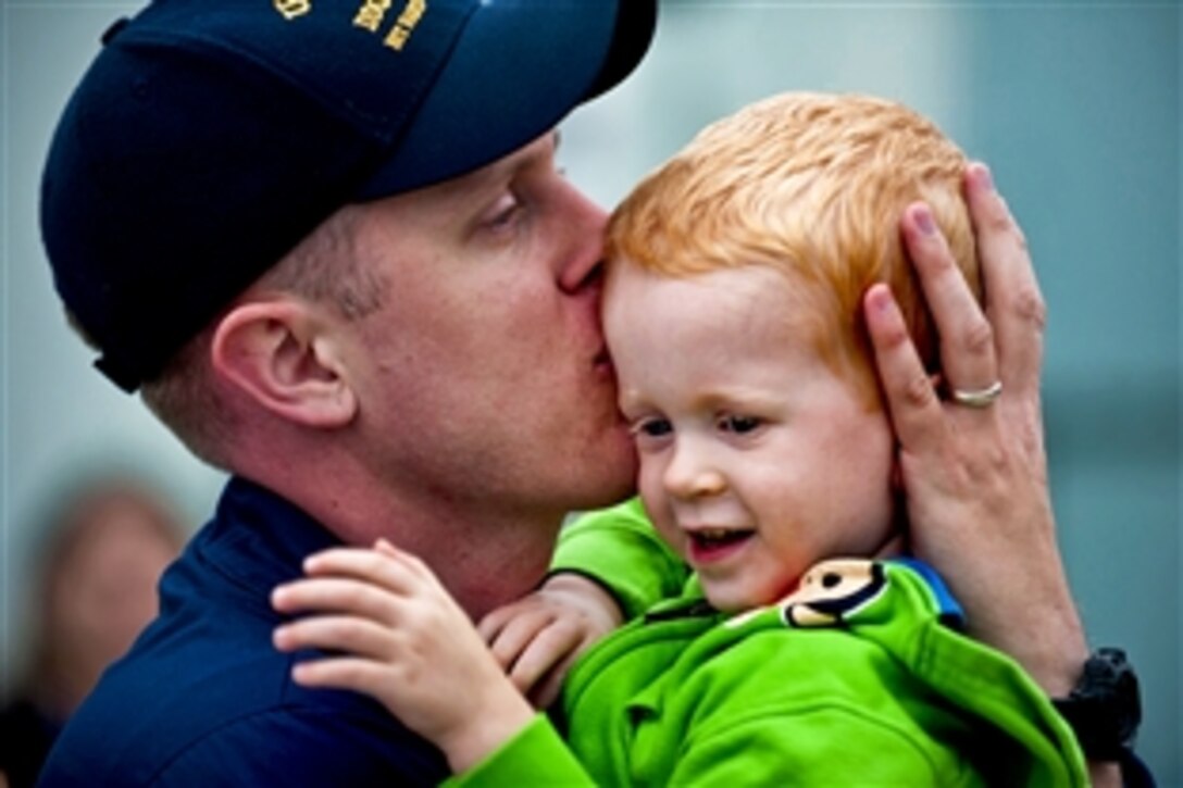 U.S. Navy Petty Officer 1st Class Logan Brethower kisses his son on the pier before deploying aboard the guided-missile destroyer USS Halsey in San Diego, Sept. 11, 2010. Halsey deployed with the Abraham Lincoln Carrier Strike Group as part of an ongoing rotation of forward-deployed forces to support maritime security operations around the globe. Brethower is a fire controlman.