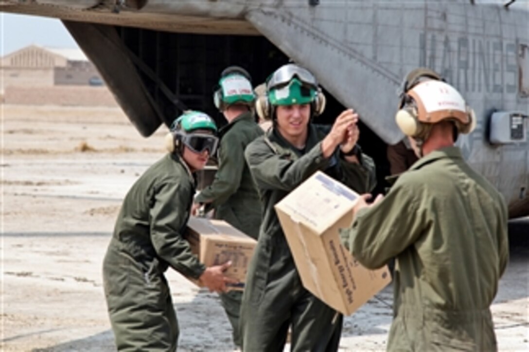 U.S. Marines from the 26th Marine Expeditionary Unit unload food and supplies from a CH-53E Sea Stallion helicopter in support of the flood relief effort in Pano Aqil, Pakistan, on Sept. 10, 2010.  