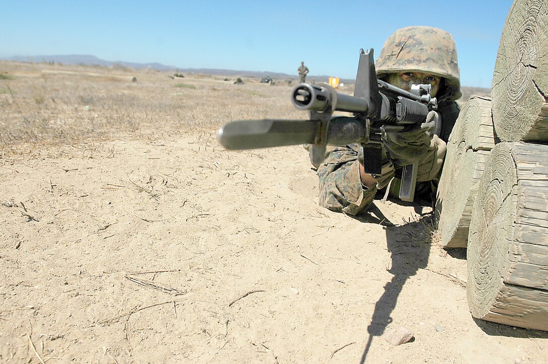 Recruit Dylan Renbarger-DeWulf, Platoon 3248, aims downrange at simulated tire-enemies to provide cover for his fire team during the Janson’s Thrust bayonet assault course event of the Crucible at Edson Range, Marine Corps Base Camp Pendleton, Calif., Sept. 14. During the course, four-man fire teams conduct buddy rushes and overcome obstacles to assault simulated tire-enemies with bayonet equipped rifles.