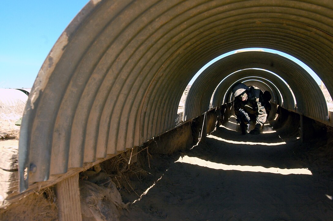Recruit Scott Herma, Platoon 3247, trudges through one of the tunnels of Janson’s Thrust, a bayonet assault course where recruits don real bayonets and use teamwork as they seek and destroy simulated tire-enemies.
