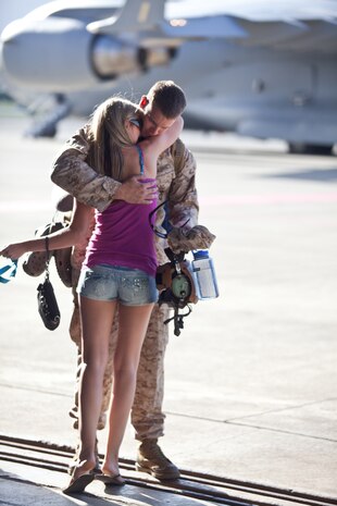 Lance Cpl. Bradley Simich, a Marine Heavy Helicopter Squadron 362 airframe mechanic, hugs his wife before stepping onto a C-17 at Marine Corps Air Station Kaneohe Bay Sept. 14. The Marines loaded at Hangar 105 before heading to Afghanistan in support of Operation Enduring Freedom.