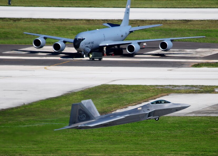 ANDERSEN AIR FORCE BASE, Guam ? A KC-135 Stratotanker is seen in the background as an F-22 Raptor takes off on the Andersen flightline while participating in the Valiant Shield 2010 exercise, here Sep. 14.  The aircraft are a key component of the major joint flying exercise that kicked off this week. (U.S. Air Force photo by Airman 1st Class Jeffrey Schultze)