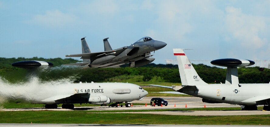 ANDERSEN AIR FORCE BASE, Guam ? Two E-3 Sentries  are seen in the background as an F-15C Eagle takes off on the Andersen flightline while participating in the Valiant Shield 2010 exercise, here Sep. 16.  The aircraft are a key component of the major joint flying exercise that kicked off this week. (U.S. Air Force photo by Airman 1st Class Jeffrey Schultze)