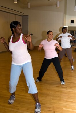 Staff Sgt. Shantee Hill, 8th Medical Group medical technician, performs dance moves during a Zumba exercise routine with other participants at the base gym, Kunsan Air Base, Republic of Korea, Sept. 15, 2010. Zumba is a dance fitness program combining Latin and international music with dance in an effort to make exercise fun. (U.S. Air Force photo/Staff Sgt. Jonathan Pomeroy) 