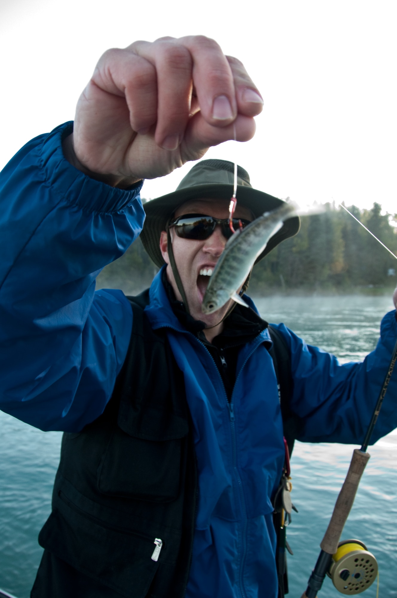 JOINT BASE ELMENDORF-RICHARDSON, Alaska -- Project Healing Waters Alaska Program Director Air Force Staff Sgt. Mike Henrie, U.S. Air Force Band of the Pacific, marvels at the size of his catch, Sept. 11. (Air Force photo by Airman 1st Class Jack Sanders)