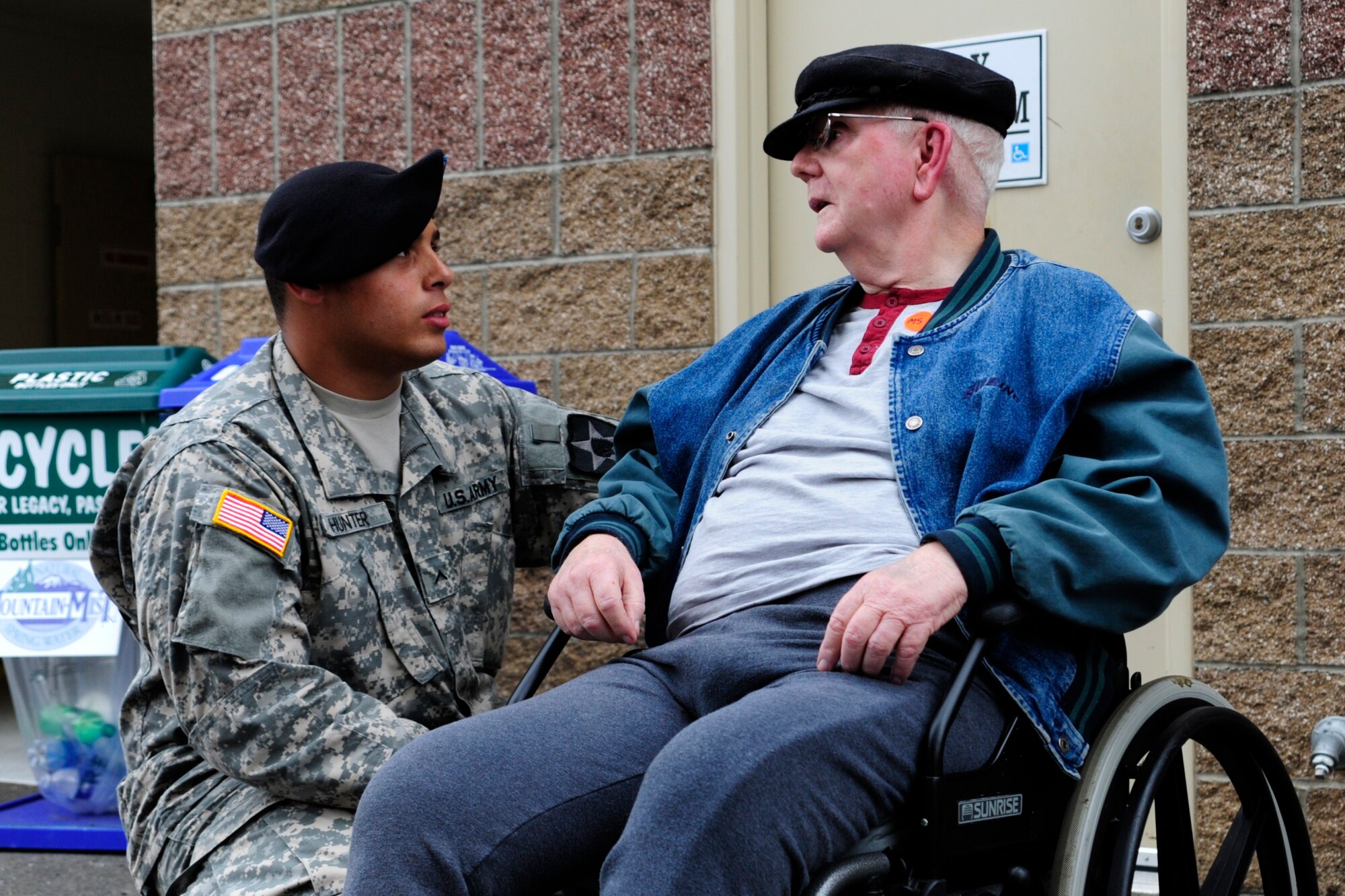 Pvt. Christopher Hunter, assigned to Joint Base Lewis-McChord, Wash., speaks to Edward Allen, a veteran from the Washington State Soldiers Home, Sept. 15 at the Puyallup Fair in Puyallup, Wash. Airmen, Soldiers and Sailors assigned to JBLM escorted veterans to the fair, giving the active duty members a chance to connect with veterans. (U.S. Air Force Photo/Airman Leah Young)