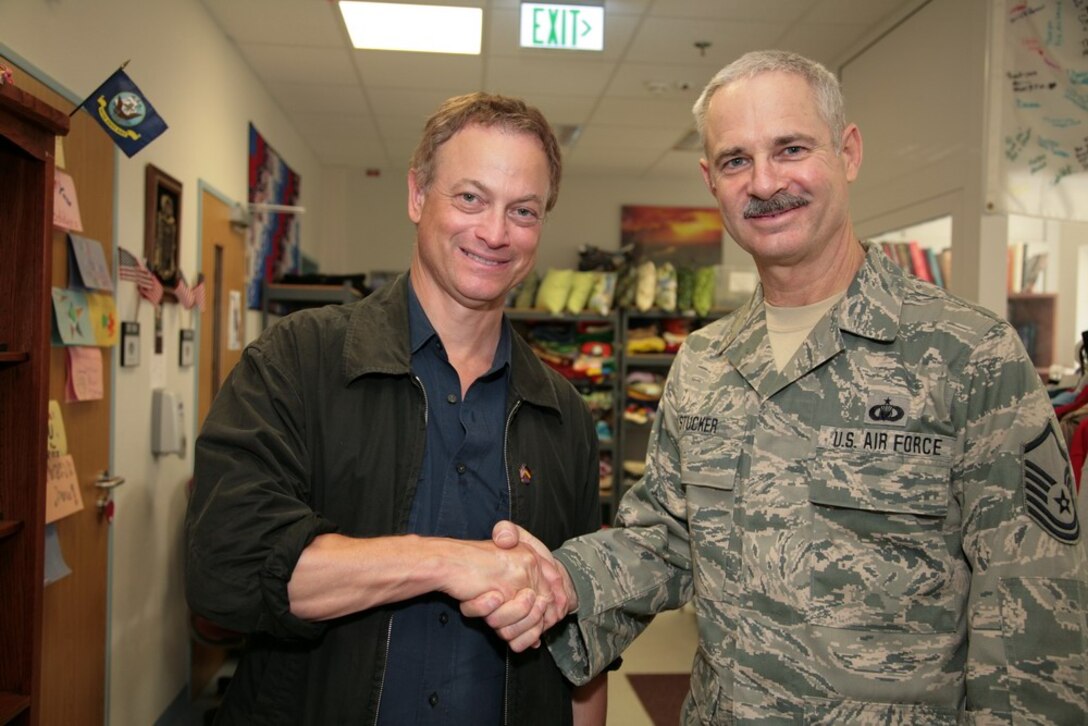 Master Sgt. Don Stucker (right) shakes hands with Gary Sinise. Stucker is currently deployed and Sinise was touring with his “Lt Dan Band” in support of U.S. military members. (photo provided)