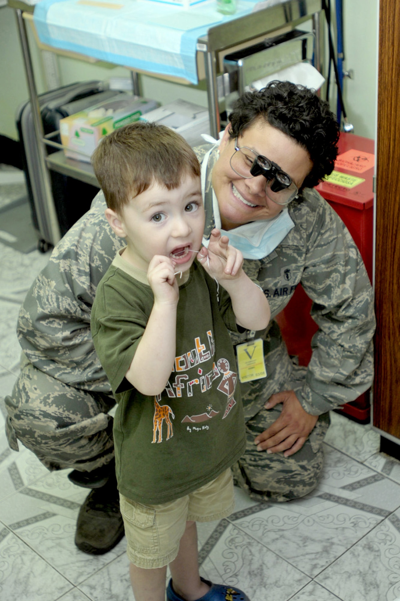 The son of an embassy worker shows Lt. Col. (Dr.) Jacqueline Garcia-Castellanos that he knows how to floss his teeth Sept. 12, 2010, in Kinshasa, Democratic Republic of the Congo. Colonel Garcia-Castellanos, a reservist with the 482nd Aeromedical Dental Squadron, Homestead Air Reserve Base, Fla., is in the DRC as part of MEDFLAG 10, a joint training exercise with the U.S. and FARDC militaries focusing on humanitarian and civil assistance. (U.S. Army photo/Sgt. James D. Sims) 