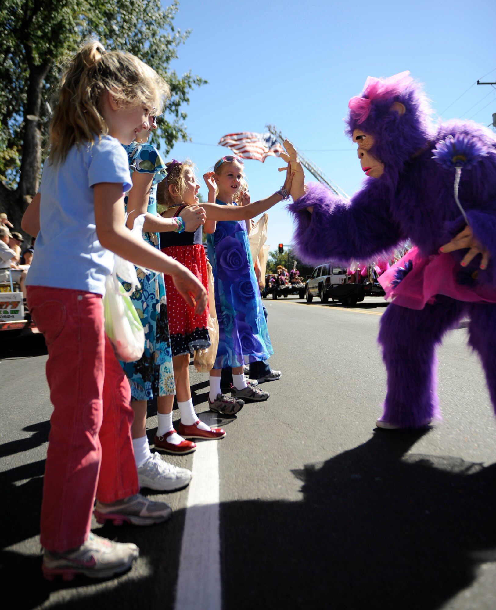 MOUNTAIN HOME AIR FORCE BASE, Idaho -- Children give high-fives to a purple gorilla high during the Air Force Appreciation Day parade in Mountain Home Sept. 11.This was the 50th anniversary of the AFAD celebration, which celebrates the friendship and partnership between the community and base. (U.S. Air Force photo by Senior Airman Renishia Richardson)