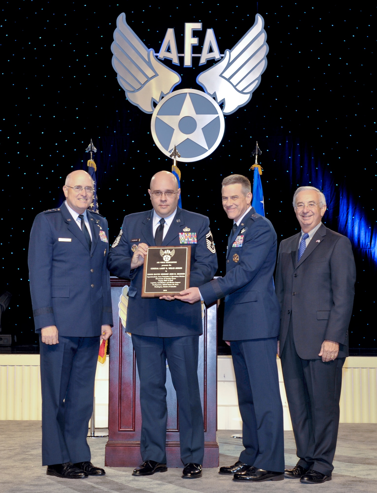 Lt. Gen. Loren M. Reno (left), Maj. Gen. William A. Chambers (center right), and Joseph Sutter (right) present the first Gen. Larry D. Welch award for individual excellence and achievement in the Air Force nuclear enterprise to Senior Master Sgt. John M. Oblinger Sept. 13, 2010, at the 2010 Air Force Association Air and Space Conference and Technology Exposition at National Harbor in Oxon Hill, Md. Sergeant Oblinger is the superintendent of the force protection and operations division for installations and mission support. He constructed the first Air Force Nuclear Security Roadmap and led the rewrite of the Air Force Nuclear Security Manual in a record 140 days, a process that could take more than 18 months to complete. General Reno is the deputy chief of staff for installations and mission support. General Chambers is the assistant chief of staff for strategic deterrence and nuclear integration. Mr. Sutter is the president of the Air Force Association. (U.S. Air Force photo/Michael Pausic)