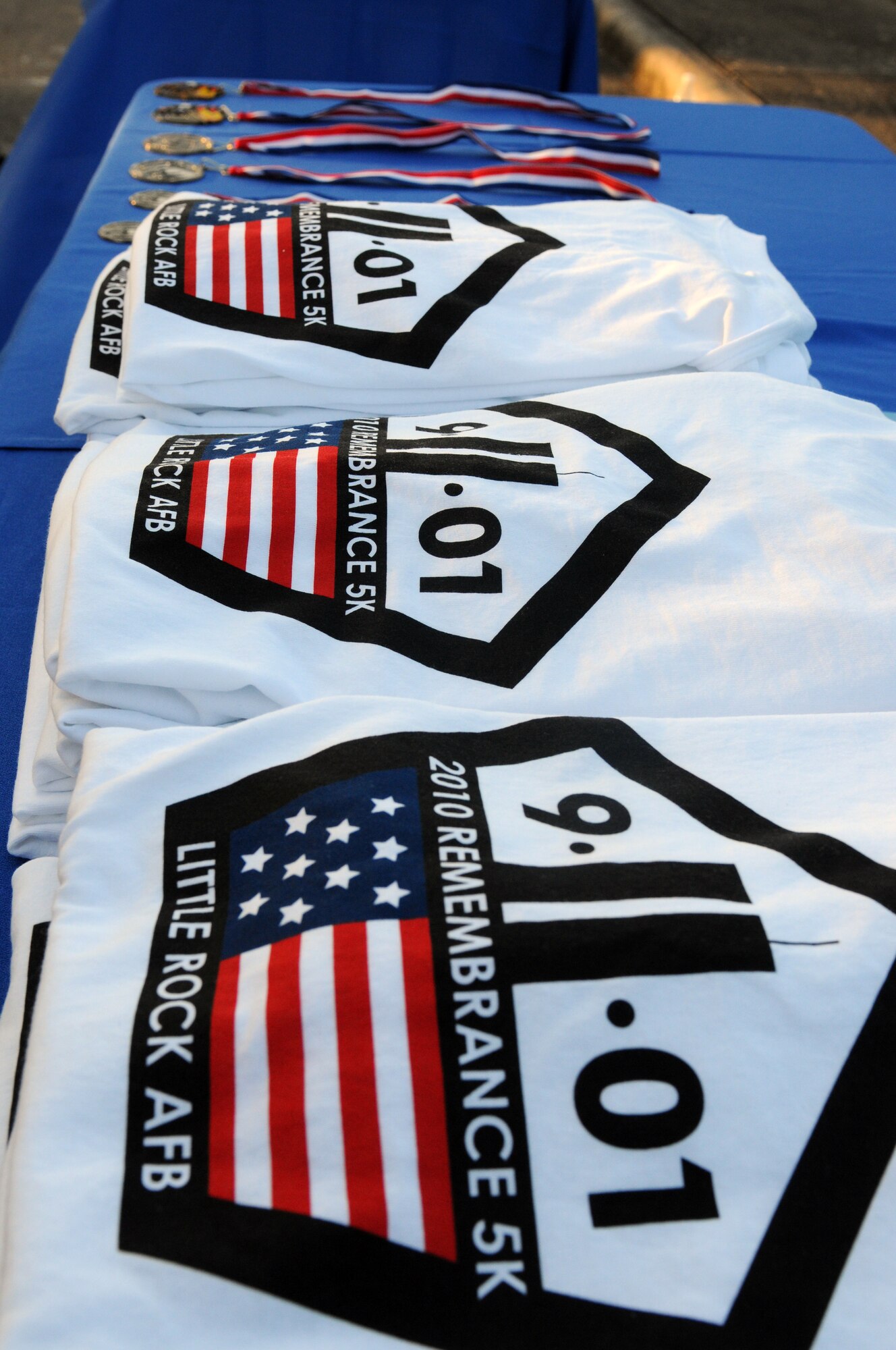 Medals and T-shirts await the top finishers of the Sept. 11 Remembrance 5K run Sept. 10 here. Medals were awarded to the top three finishers in both male and female divisions while T-shirts were given to the first 25 participants to cross the finish line. (U.S. Air Force photo by Staff Sgt. Chris Willis)