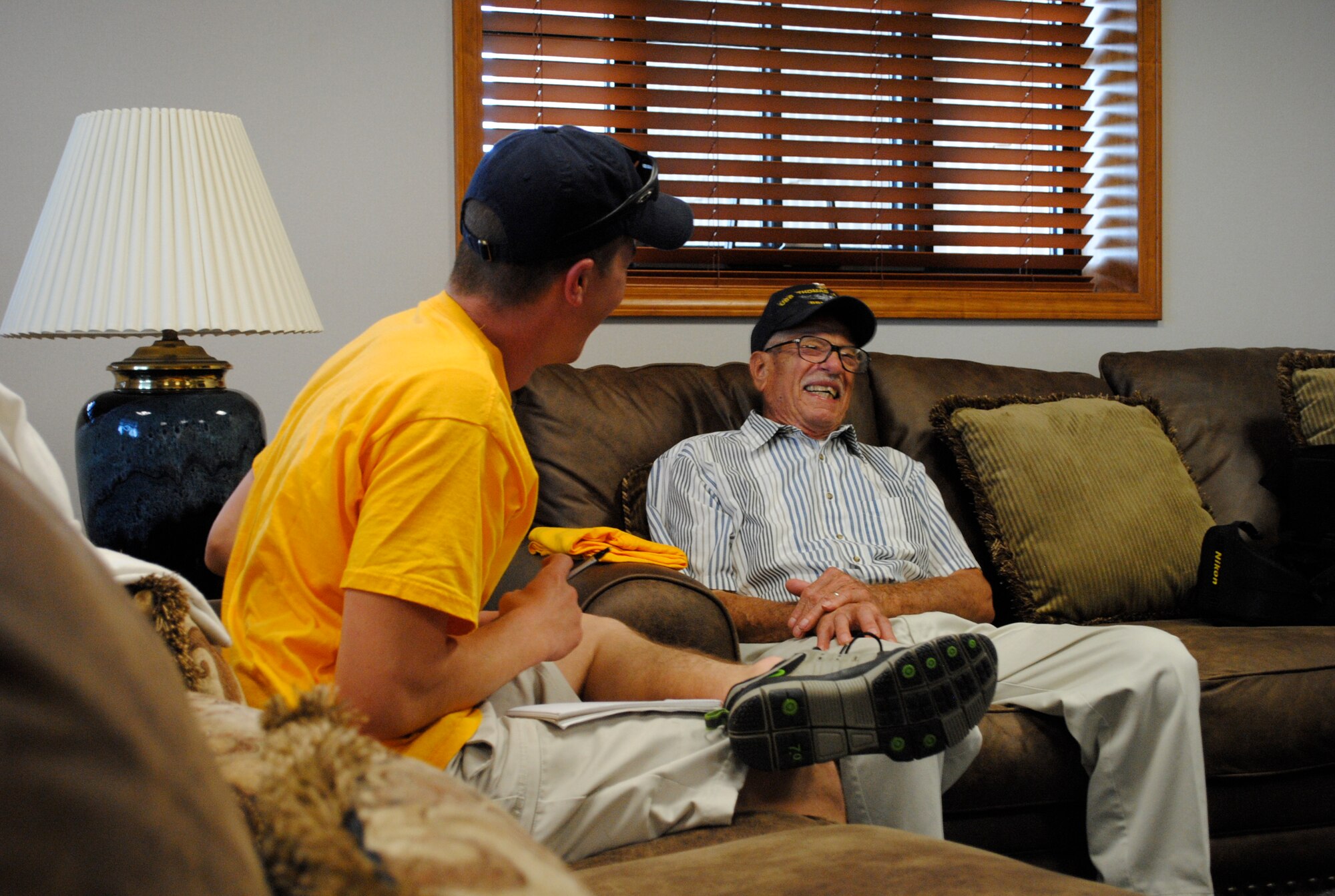 Retired Navy Master Petty Officer Mike Kovach (right) tells 2nd Lt. Daniel Riley about his experience aboard the USS Whitney on the day Pearl Harbor was attacked. Chief Kovach attended the air show at Scott and watched Tora!, Tora!, Tora! re-create the attack. (U.S. Air Force photo/Bekah Clark)  