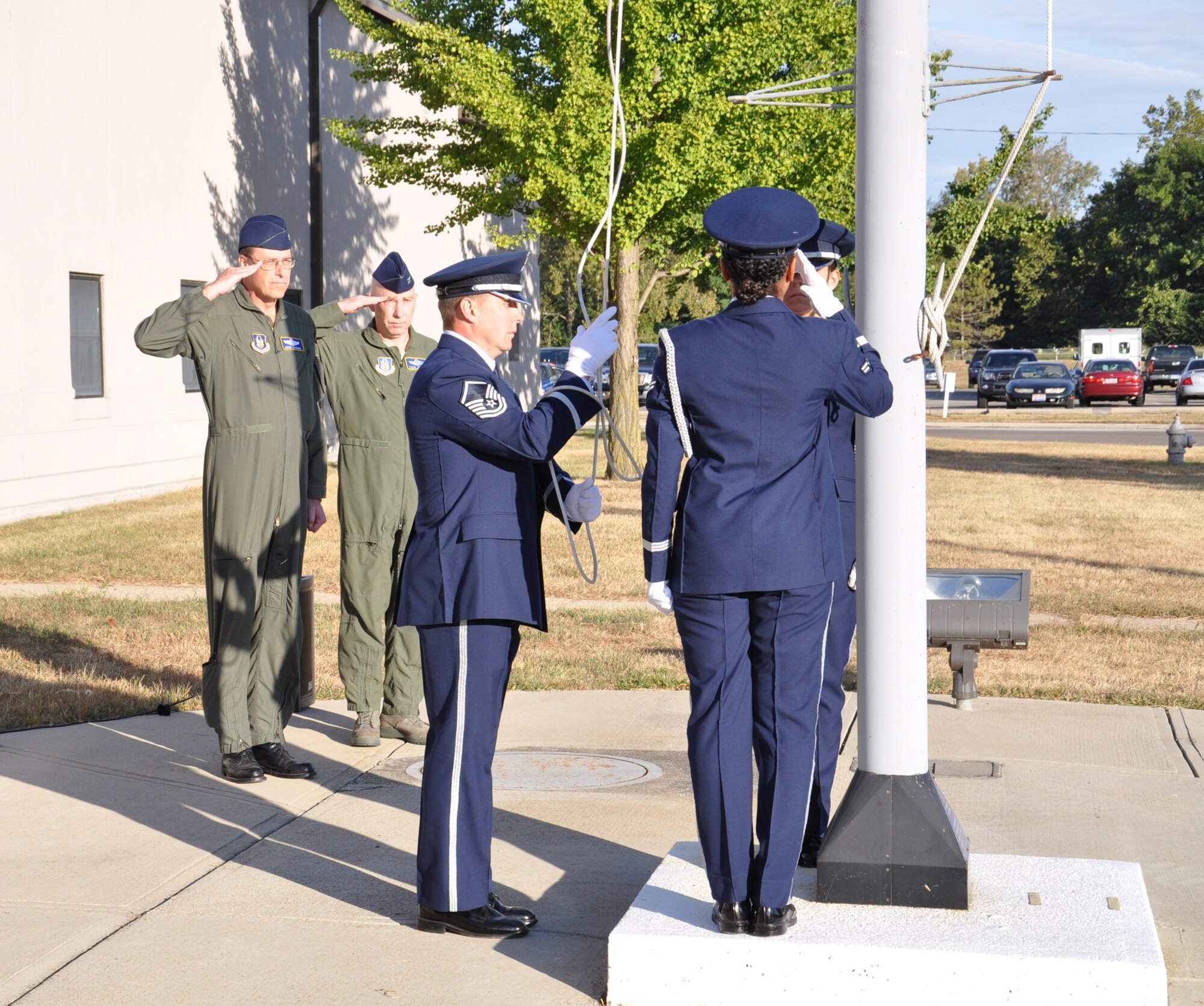 WRIGHT-PATTERSON AIR FORCE BASE, Ohio – Col. Stephen Goeman, 445th Airlift Wing commander, and Col. Steven Johnson, 445th Airlift Wing vice commander, watch the 445th AW Honor Guard raise the flag during a memorial and remembrance service Sept. 11 at the flagpole outside the 445th AW headquarters building. The service was held to remember and honor those who lost their lives nine years ago during the World Trade Center and Pentagon attacks. (U.S. Air Force photo/Senior Airman Matthew Cook)