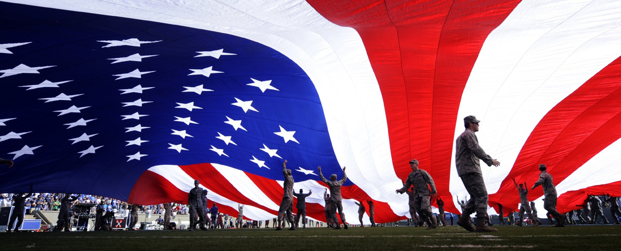 Cadets keep a large American flag aloft during a Sept. 11 memorial ceremony during halftime of the Air Force-BYU game at Falcon Stadium Sept. 11, 2010. The flag measured about 55 yards by 30 yards. NYPD detective Steve Hayden and FDNY firefighter Kenny Haskell, responders during the World Trade Center attack Sept. 11, 2001, were honorary team captains at the game. (U.S. Air Force photo/Dennis Rogers)