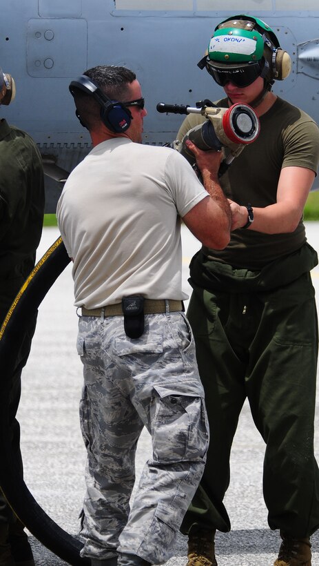 Members of the 36th Logistics Readiness Squadron and Marine Wing Support Squadron 171 perform a hotpit refuel on a F/A 18 Delta Hornet on the flightline here Sept. 14. Different units across the U.S. military are at Andersen Air Force Base, Guam, participating in Valiant Shield, an integrated joint training and interoperability exercise among U.S. military forces. (U.S. Air Force photo by Airman Julian North)
