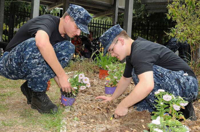 Firemen Matt Cook and Cody Millsap, assigned to Naval Nuclear Power Training Command at Naval Weapons Station Charleston, lend a helping hand to Malcolm C. Hursey Elementary School during the annual Day of Caring event. More than 2,500 Sailors and Airmen from the Charleston area performed hundreds of tasks in conjunction with the Trident United Way Day of Caring community service event. (U.S. Navy photo by Mass Communication Specialist 1st Class Jennifer R. Hudson)