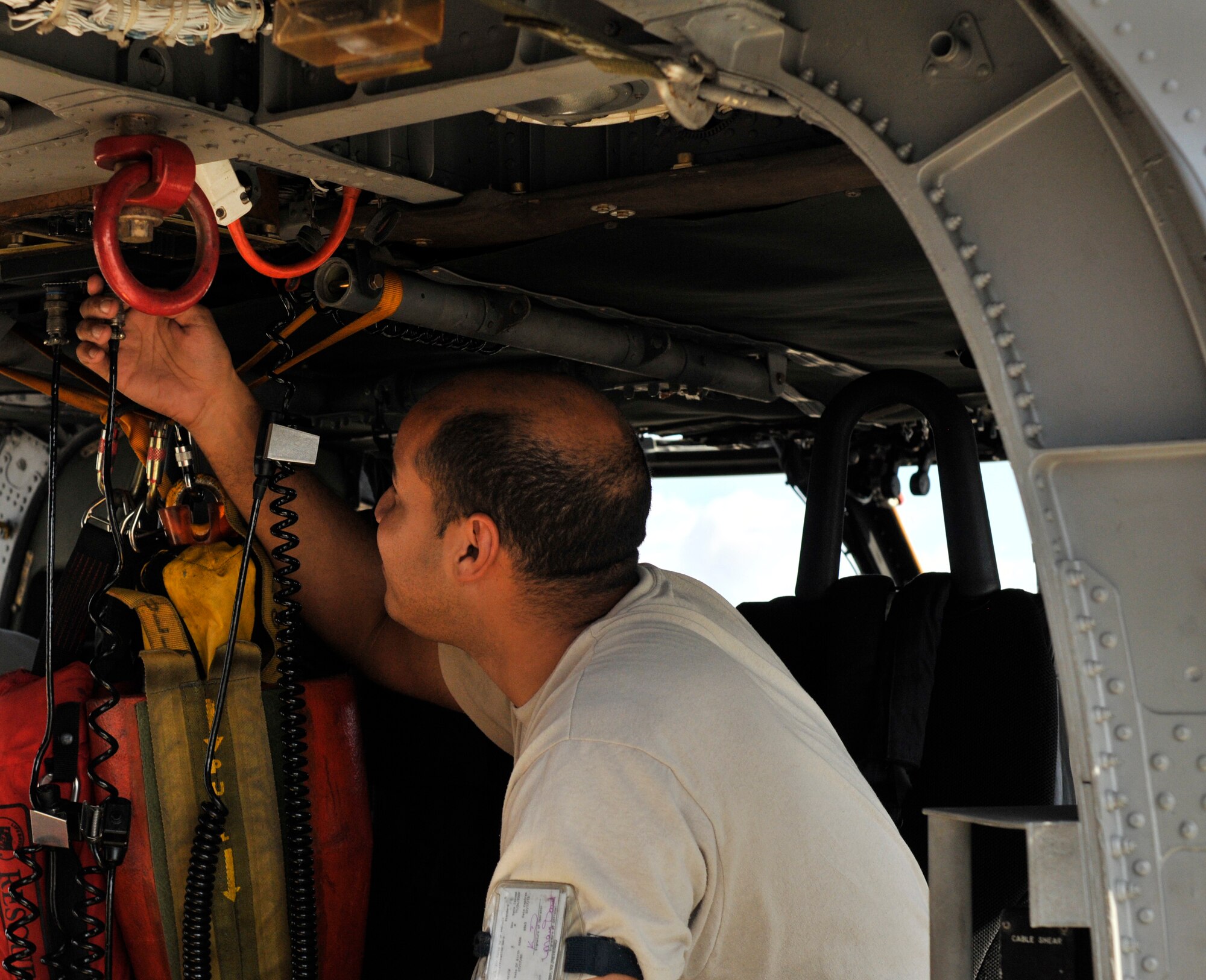 PATRICK AIR FORCE BASE, Fla. -- Senior Airman Kevin Delarosa, HH-60G Pave Hawk crew chief, 920th Maintenance Squadron, finishes pre-flight inspections here on an HH-60G Pave Hawk helicopter prior to a training mission Sept. 15. Known as "Citizen Airmen," Air Force Reservists are dedicated, dual-hatted professionals who live in your neighborhood and work in your community. When called to duty, reservists put their civilian lives on hold to defend our nation. (U.S. Air Force photo/Staff Sgt. Ken Salgat)