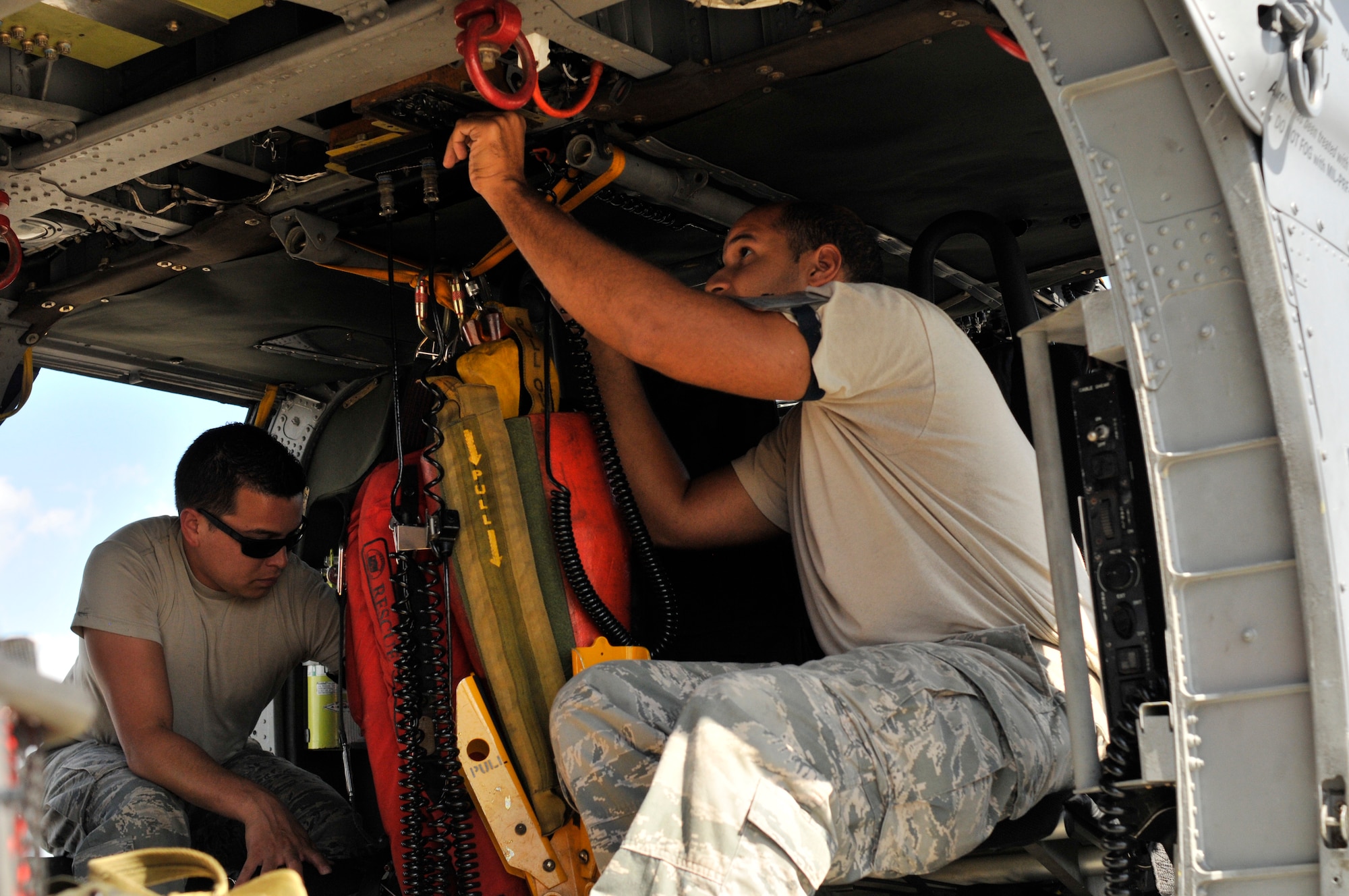 PATRICK AIR FORCE BASE, Fla. -- Airman 1st Class Christopher Fox (L) and Senior Airman Kevin Delarosa, HH-60G Pave Hawk crew chiefs, 920th Maintenance Squadron, finish pre-flight inspections here on an HH-60G Pave Hawk helicopter prior to a training mission Sept. 15. Known as "Citizen Airmen," Air Force Reservists are dedicated, dual-hatted professionals who live in your neighborhood and work in your community. When called to duty, reservists put their civilian lives on hold to defend our nation. (U.S. Air Force photo/Staff Sgt. Ken Salgat)