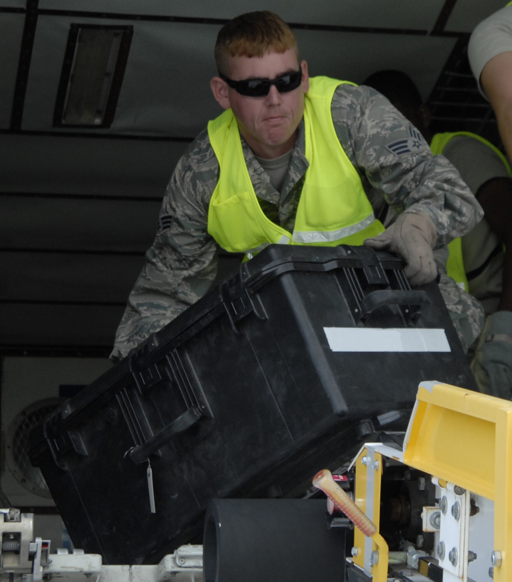 Senior Airman Joshua Purdin, 4th Special Operations Squadron, loads luggage from aircraft into a truck during Operation Homecoming at Hurlburt Field, Fla., Sept. 4, 2010.  Airman Purdin assisted the 1st Special Operations Logistics Readiness Squadron as a volunter augmentee. (DoD photo by US Air Force Airman 1st Class Joe McFadden) (RELEASED)