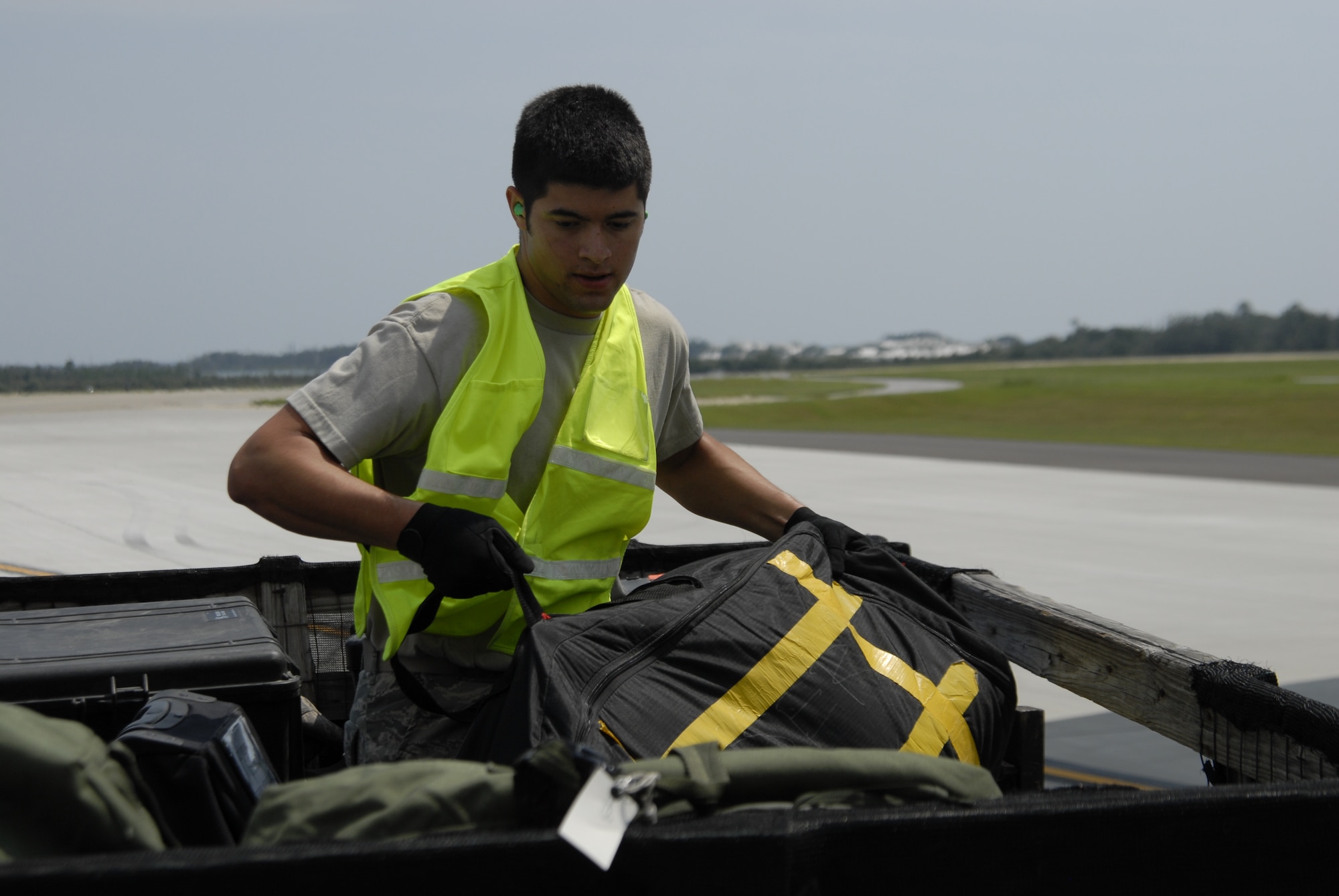 Airman 1st Class Alex Almarales, 4th Special Operations Squadron, loads luggage from aircraft into a truck during Operation Homecoming at Hurlburt Field, Fla., Sept. 4, 2010.  Airman Almarales assisted the 1st Special Operations Logistics Readiness Squadron as a volunter augmentee. (DoD photo by US Air Force Airman 1st Class Joe McFadden) (RELEASED)