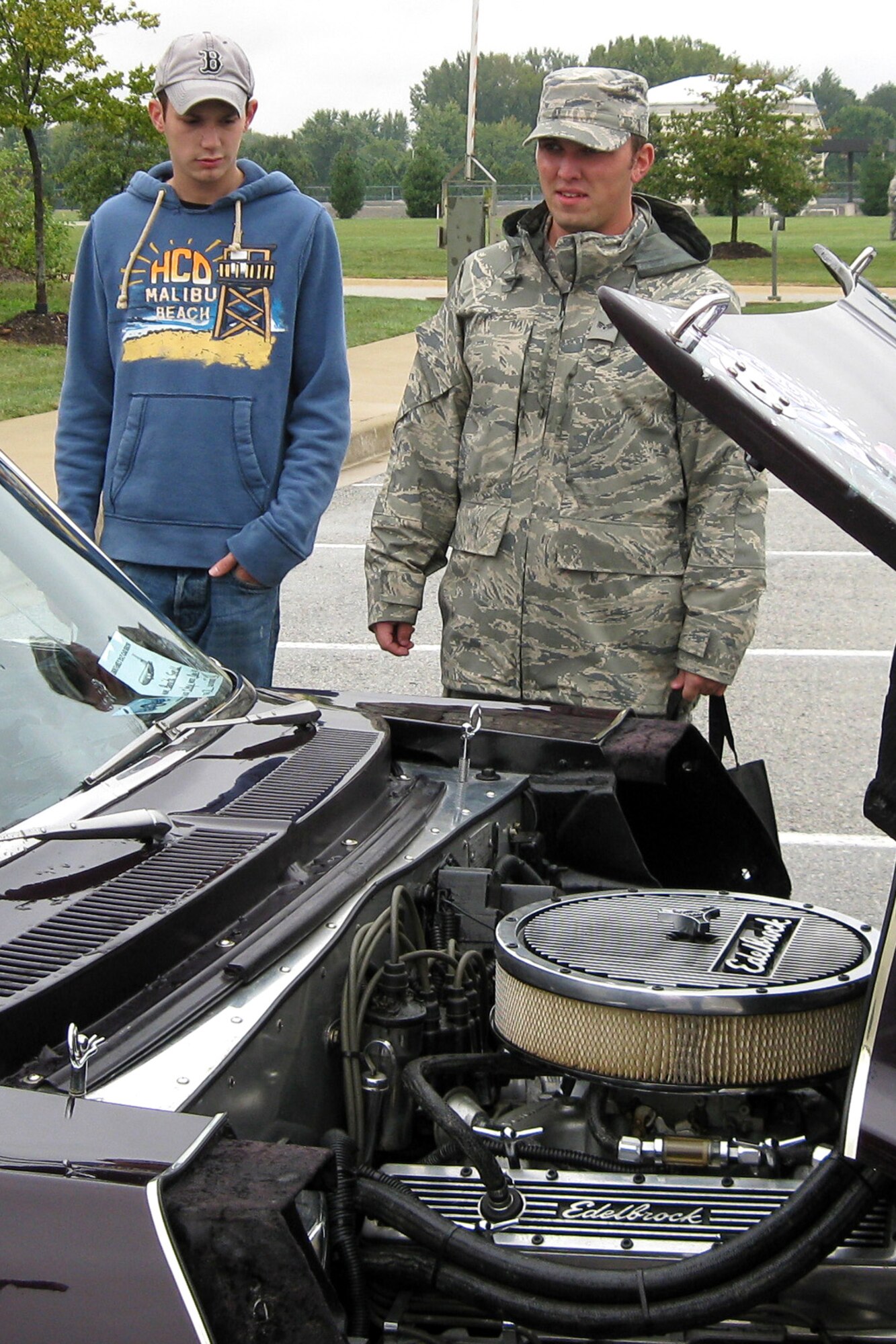 GRISSOM AIR RESERVE BASE, Ind. -- Senior Airmen Colt Allen and Nathan Foxworth admire Bonita Snell's Phantom Rose. The 1971 Chevy Nova, restored from two separate cars by a husband and wife in 28 days is part of a "His and Her's" set and was on show at Grissom as part of the Sept. 11 Family Day picnic. The Phantom Rose won the title for Best Paint. Airmen Allen and Foxworth are both assigned to the 434th Aircraft Maintenance Squadron. (U.S. Air Force photo/Capt. Kelly L. Howard)                                                       