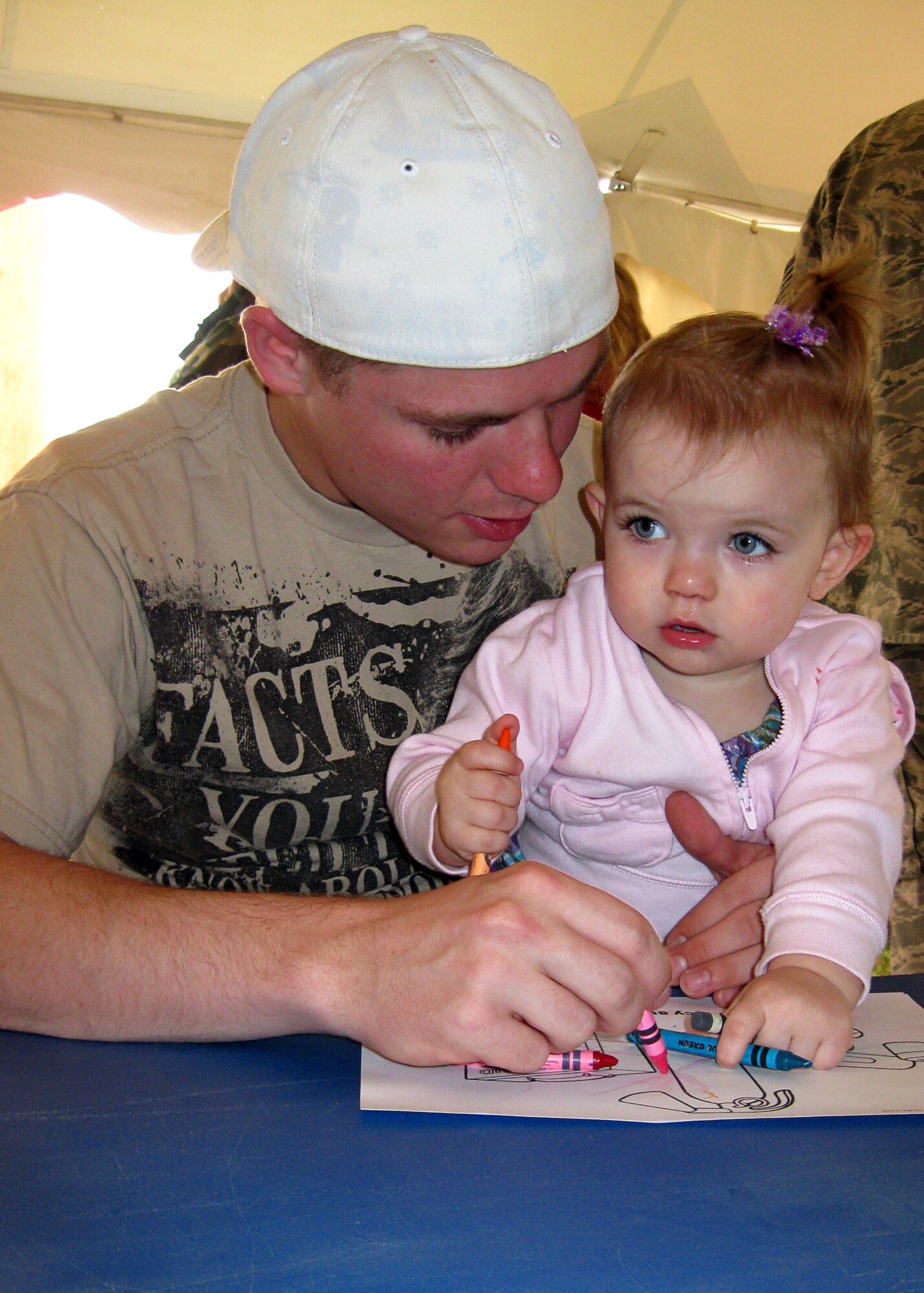 GRISSOM AIR RESERVE BASE, Ind. -- Jayden Ramler, 16 months, and her dad, Staff Sgt. Justin Ramler, color a picture during the Family Day activities Sept. 11. Sergeant Ramler is a supply management specialist with the 434th Logistics Readiness Squadron. Family Day was held to thank the families of base personnel for their support. (U.S. Air Force photo/Capt. Kelly L. Howard)