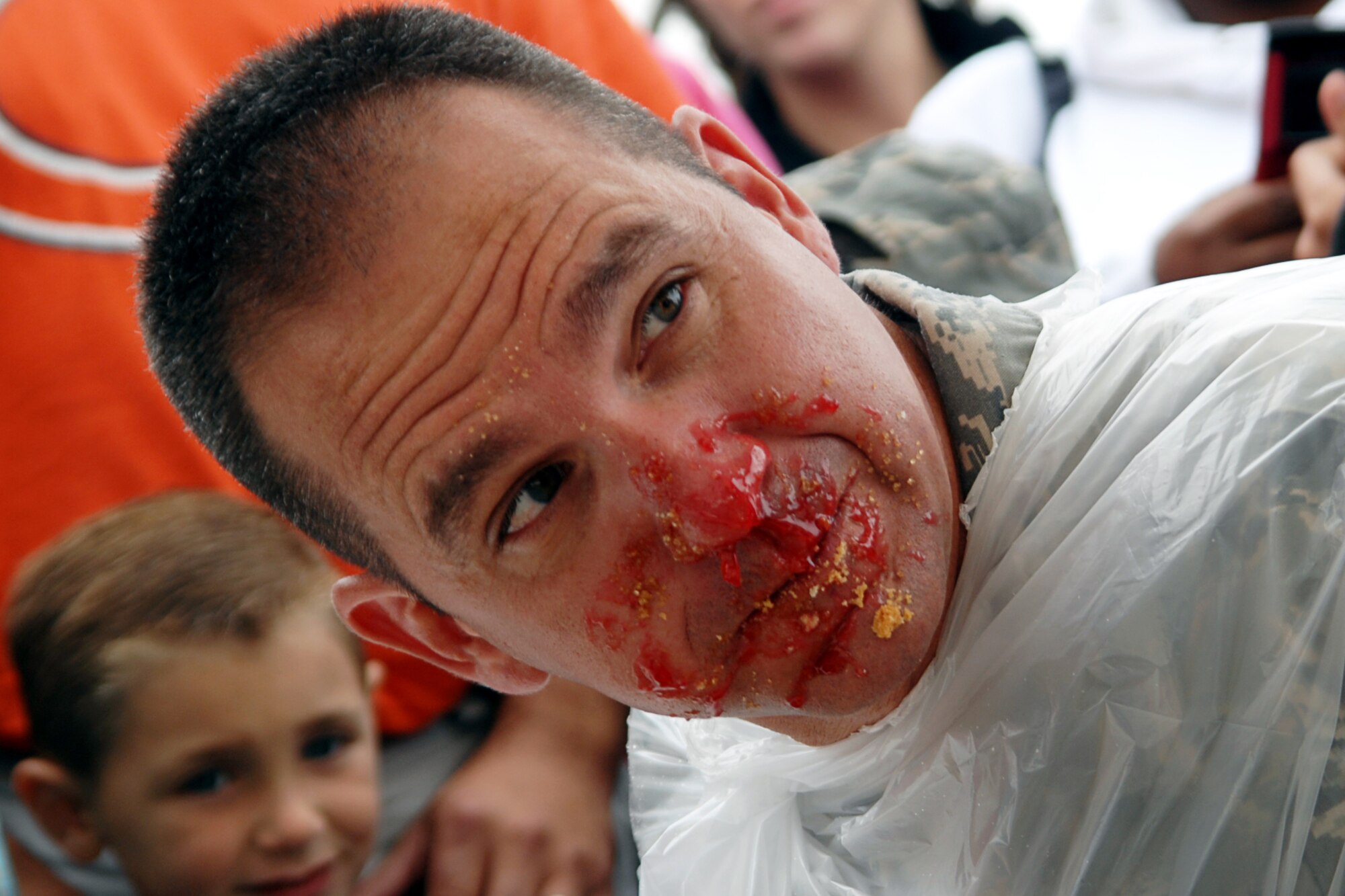 GRISSOM AIR RESERVE BASE, Ind., -- Senior Master Sgt. Chuck Hoover, a flight chief with the 434th Aircraft Maintenance Squadron,   peers at the completion as he tries to swallow more cherry pie during a pie eating contest held during the September unit training assembly. The contest drew a large crowd as competitors worked to consume their pie without using their hands. (U.S. Air Force photo/Tech. Sgt. Douglas Hays)