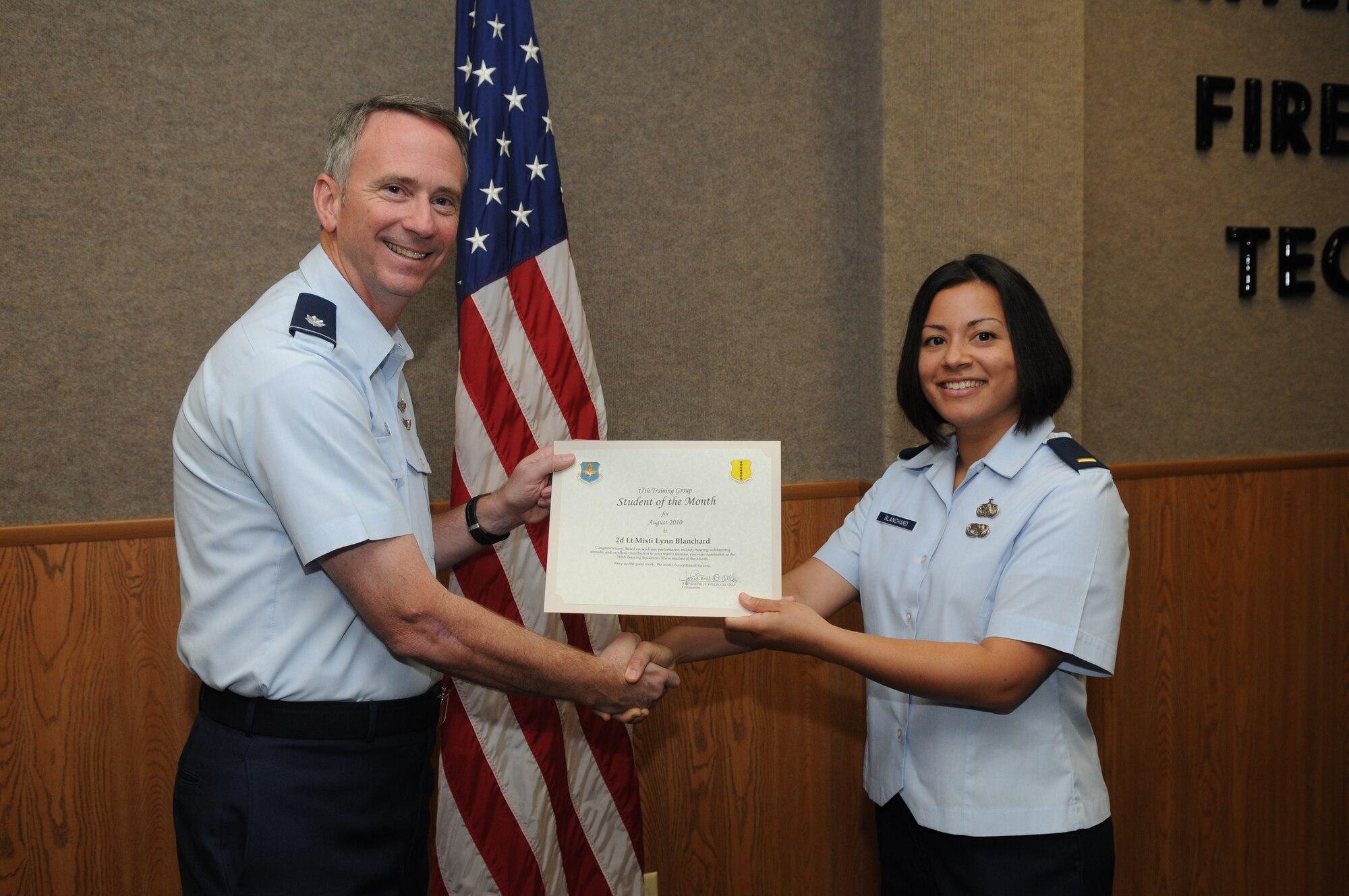 2nd Lt. Misti Blanchard, 315th Training Squadron, accepts her August Student Officer of the Month award from Lt. Col. Andrew Cupp, 17th Training Group Deputy Commander. (U.S. Air Force photo/Airman 1st Class Clayton Lenhardt)